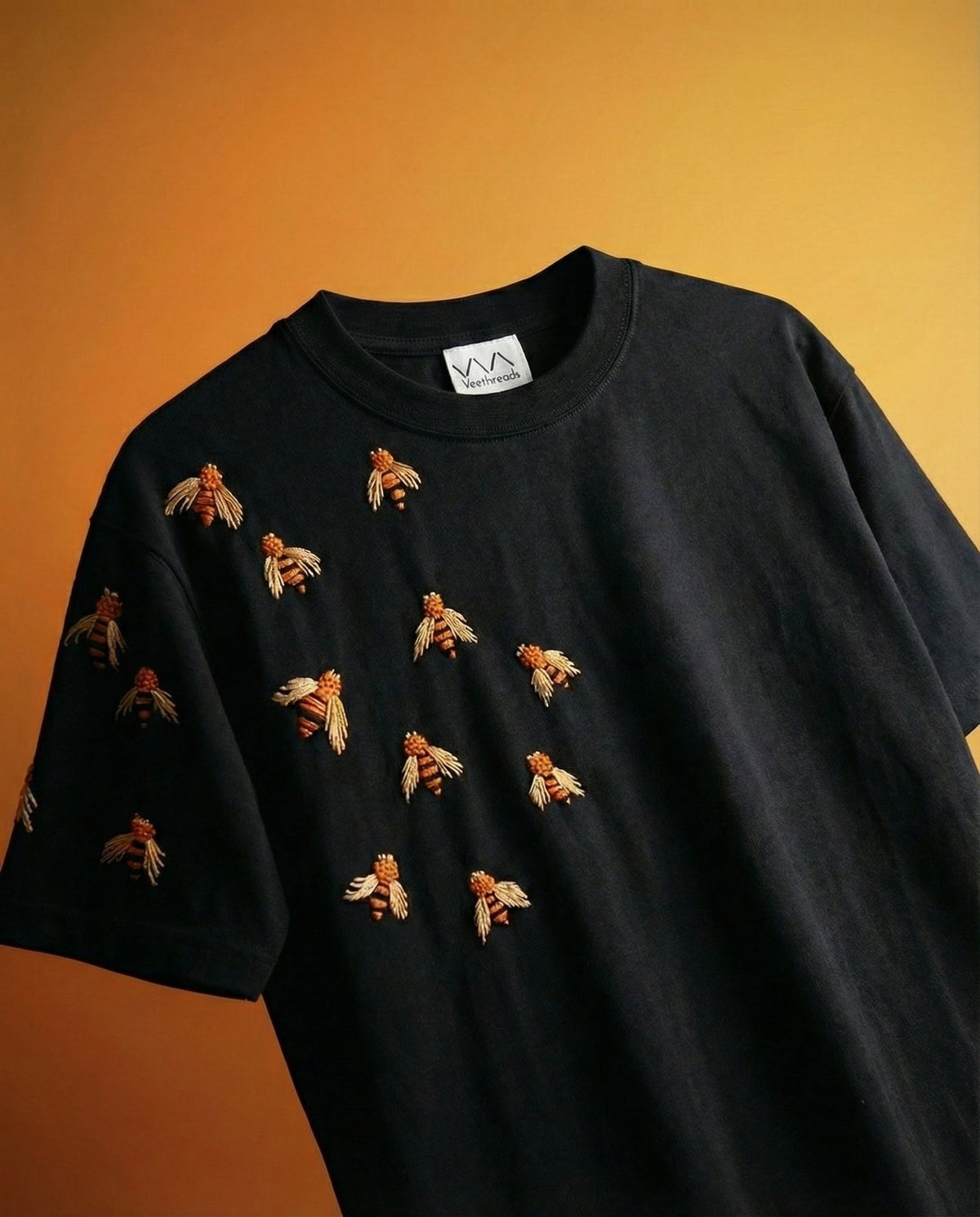 Black oversized t-shirt with golden bees hand-embroidered on the chest