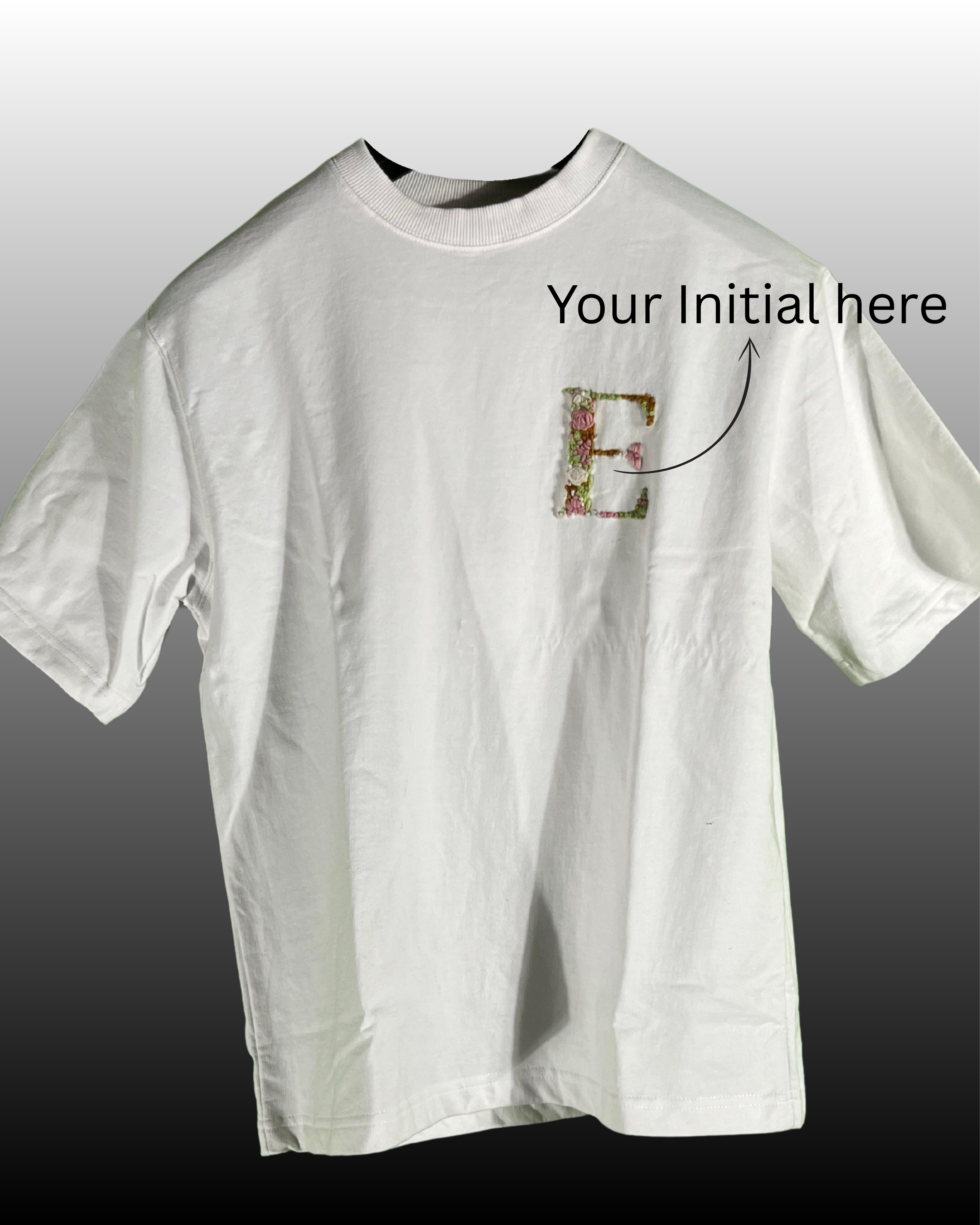 White hand-embroidered t-shirt with custom initials in a floral wreath, suitable for personalised corporate Diwali gifting