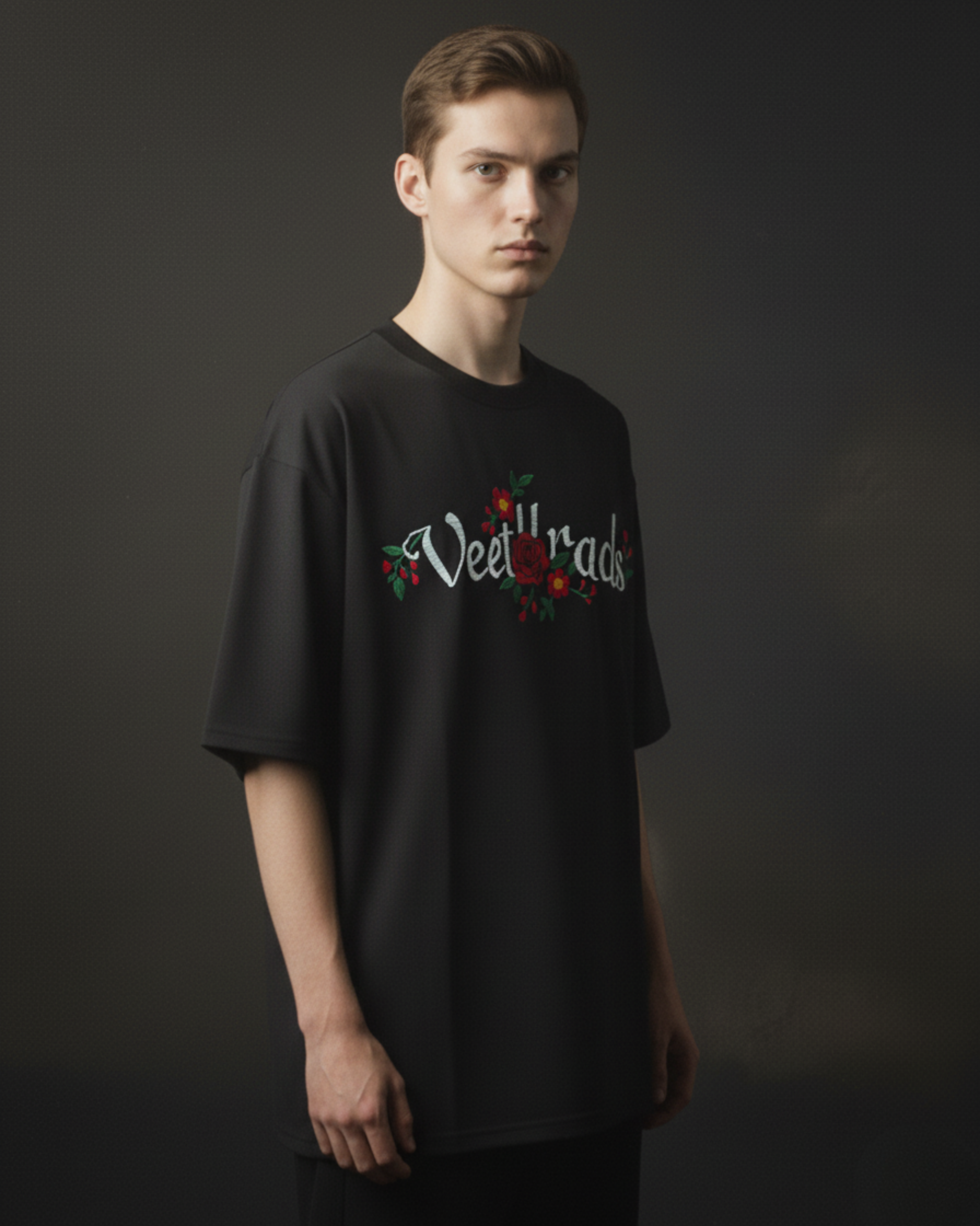 Person wearing a black t-shirt with 'Veetrad' logo against a dark background