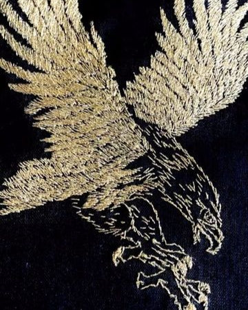 Gold embroidered eagle design on black fabric
