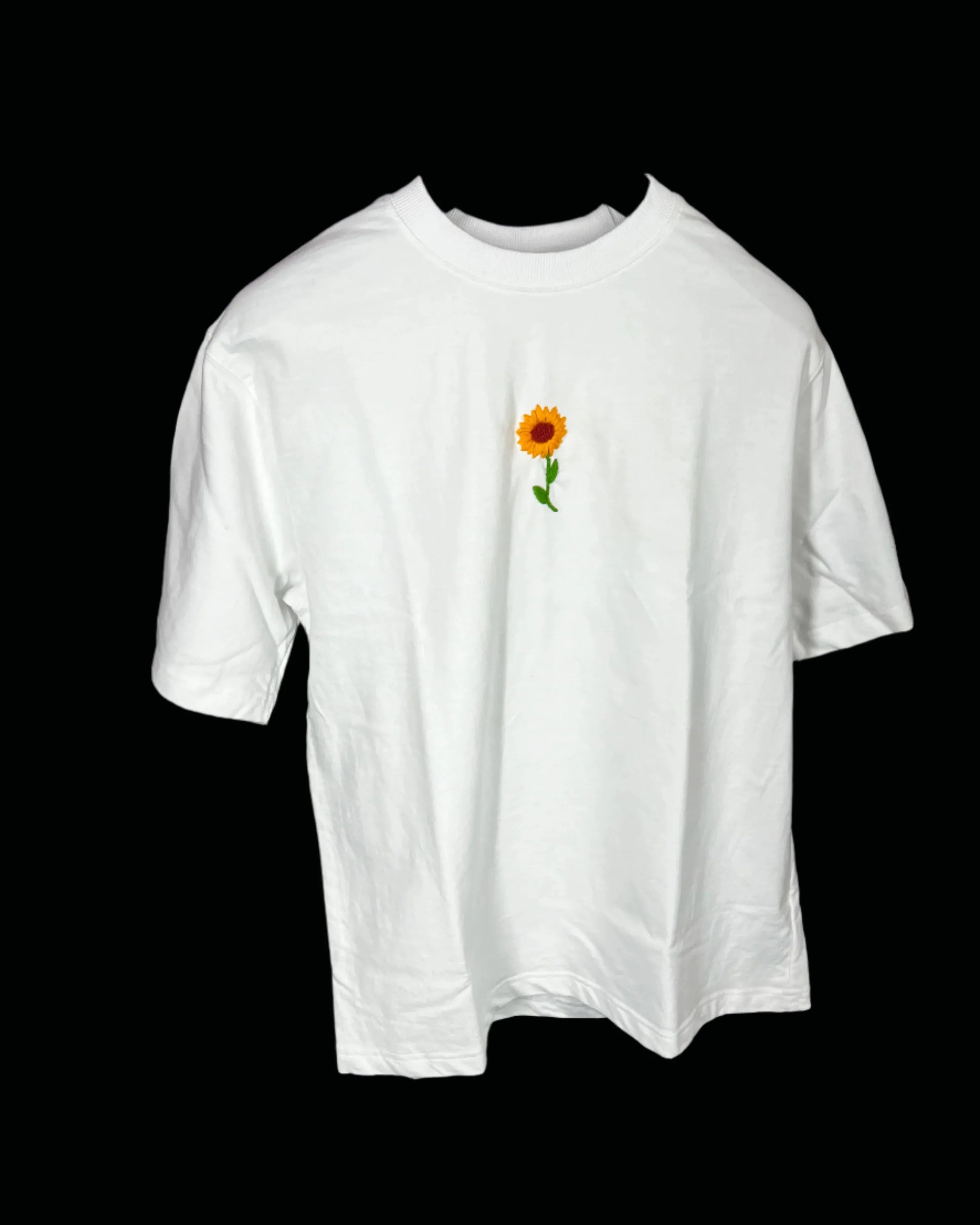 White t-shirt with a sunflower design on a black background