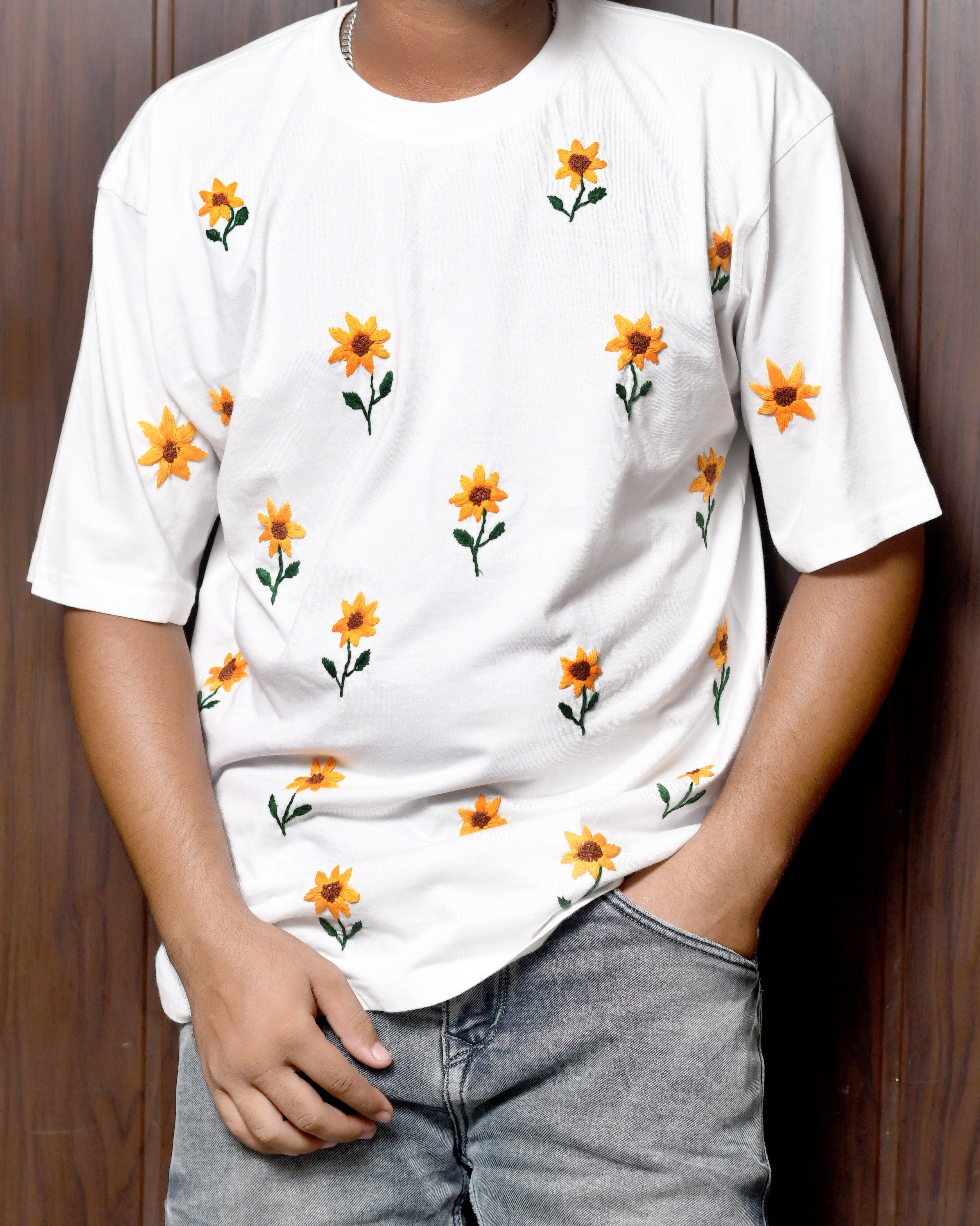 Model wearing flower embroidered t-shirt made from soft breathable cotton