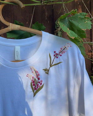 Floral hand embroidered cotton oversized t-shirt — white cotton tee with multicoloured hand-embroidered flowers on chest, oversized fit