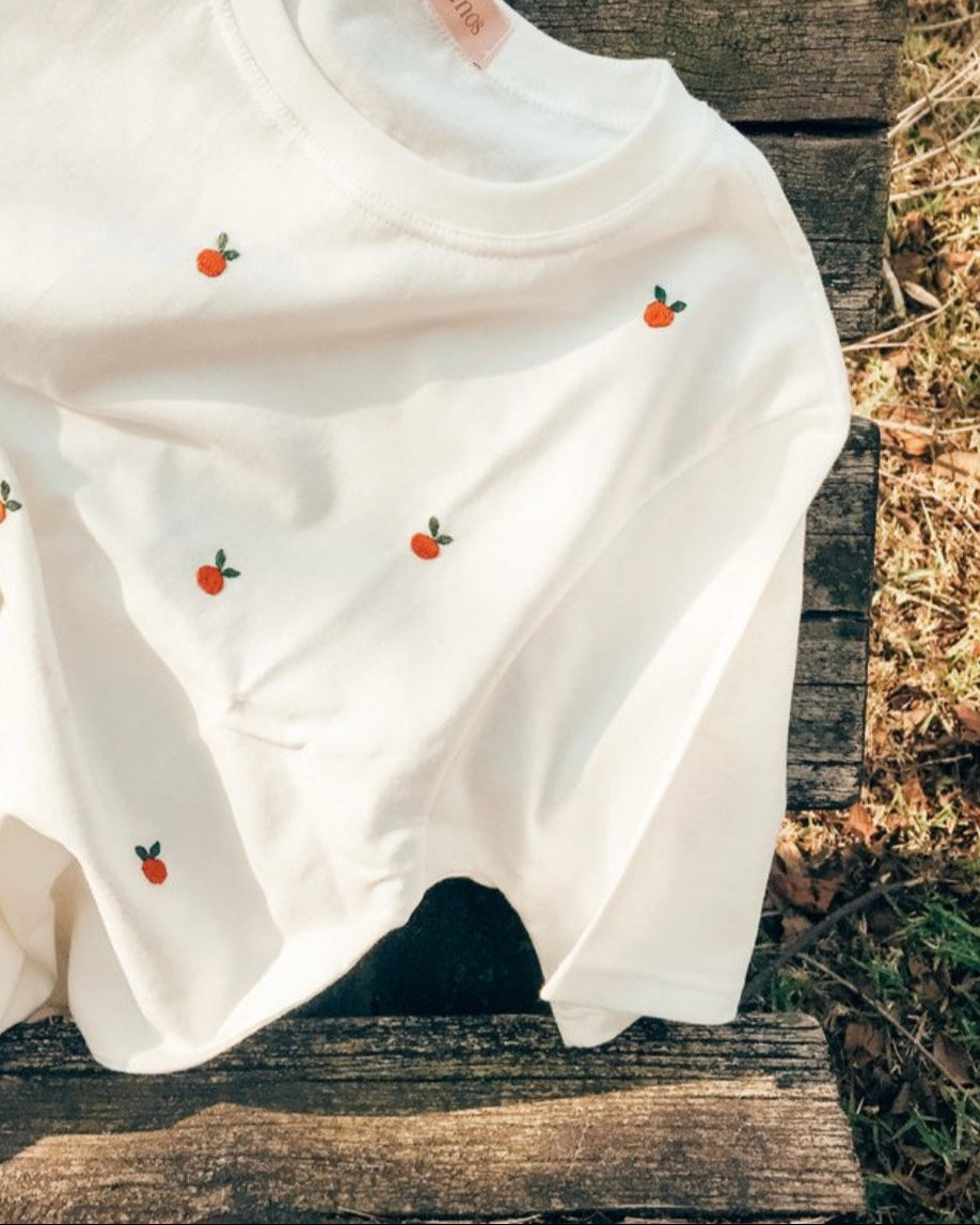 Small embroidery designs for shirts tomato — side angle of tomato embroidered tee showing soft cotton fabric and relaxed fit
