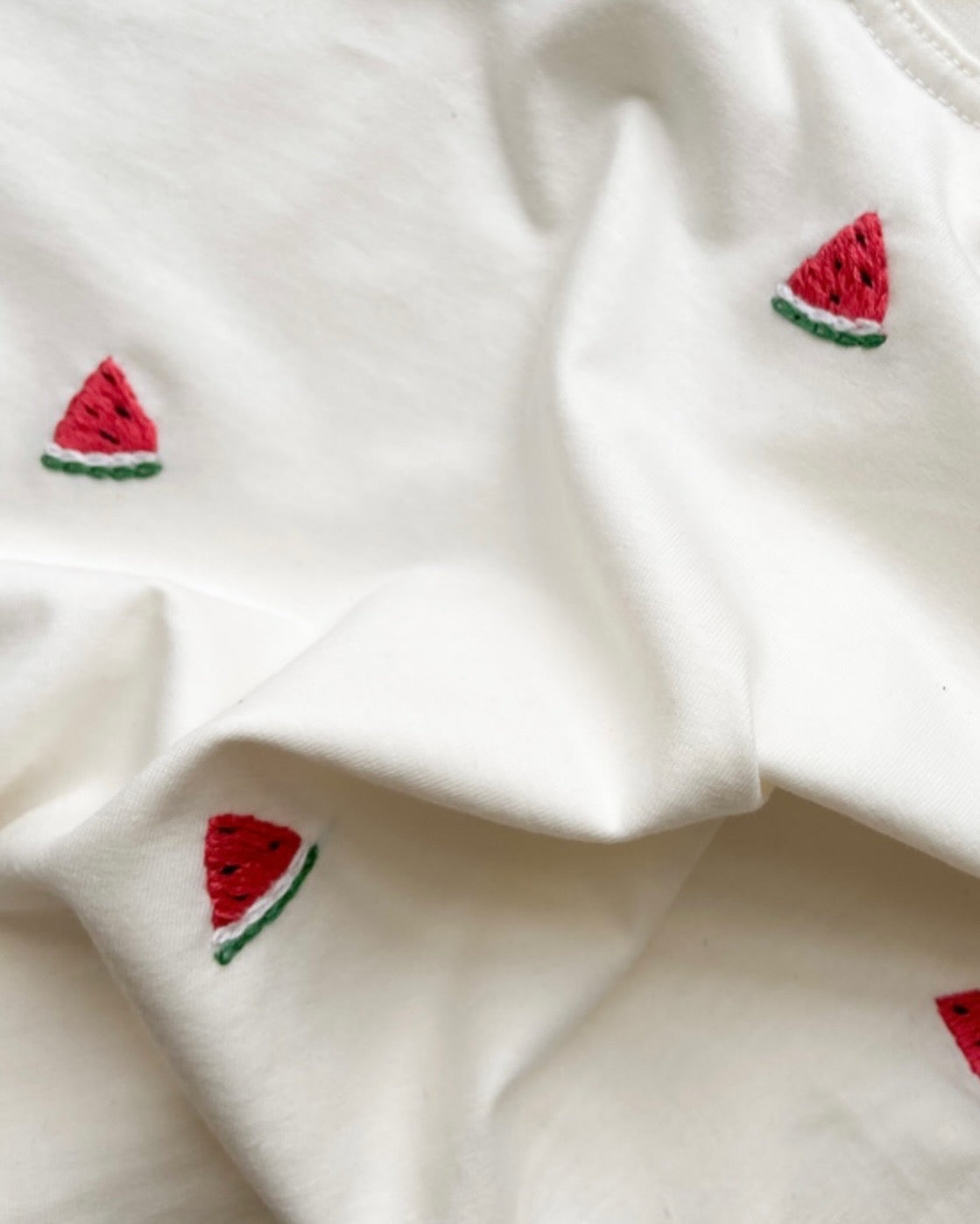 close up view of oversized watermelon embroidered t-shirt made with organic cotton