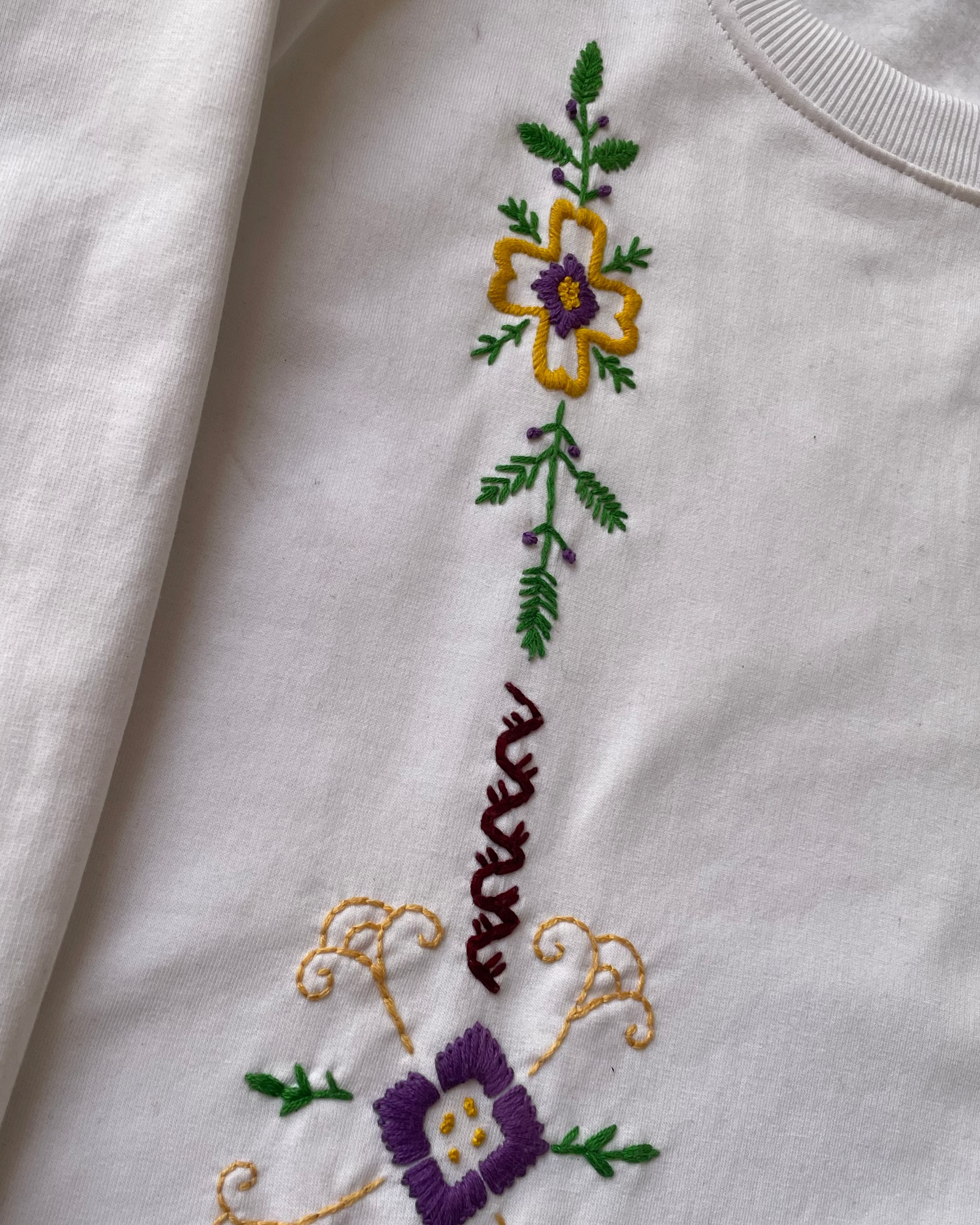 Embroidered floral design on a white hoodies