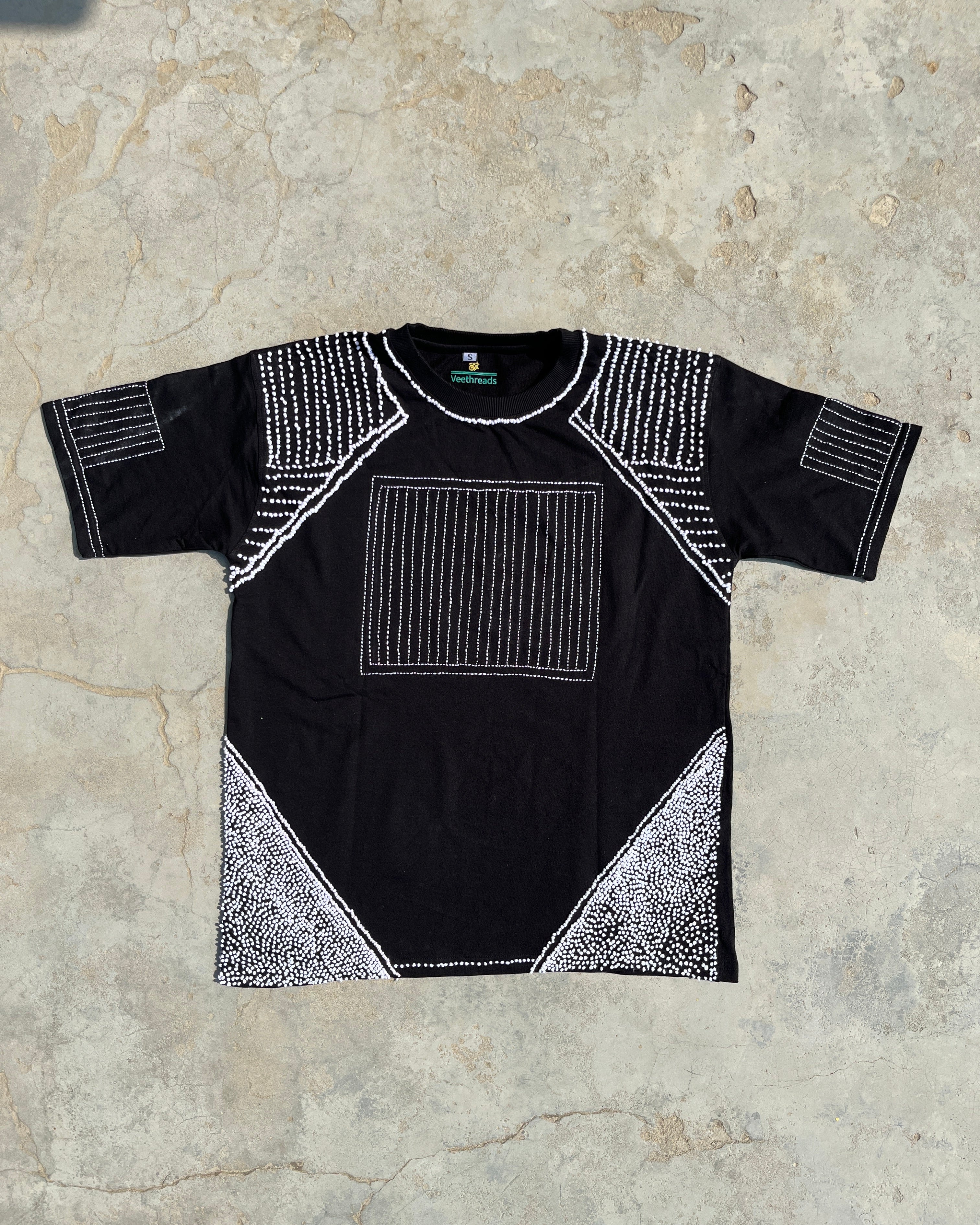 embroidered tshirt flatlaying on ground