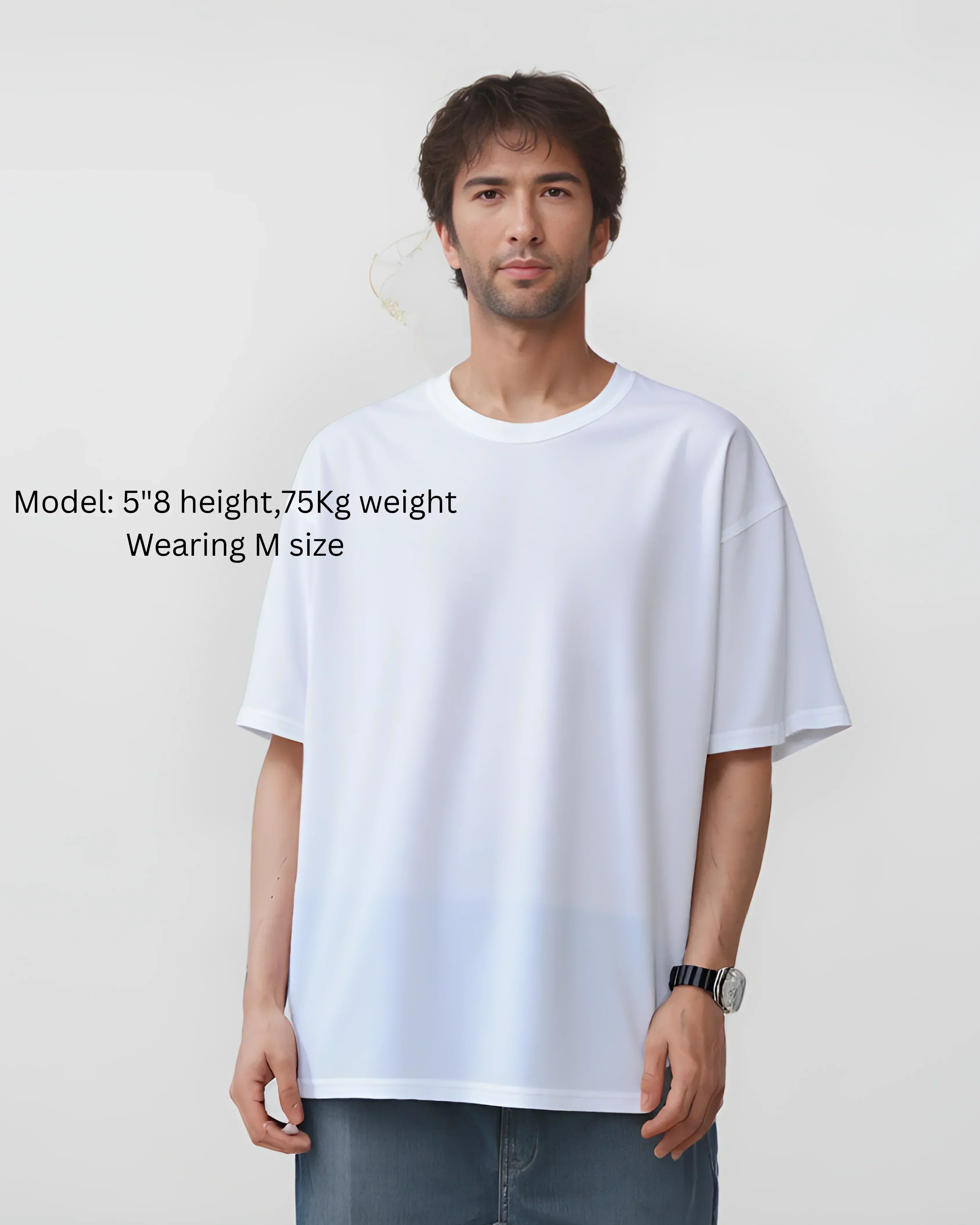 Man wearing a white oversized t-shirt on a plain background