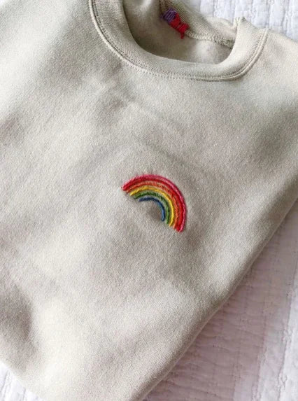 Rainbow hand embroidery t-shirt — white cotton tee with vibrant rainbow hand-embroidered on chest, oversized unisex drop shoulder fit