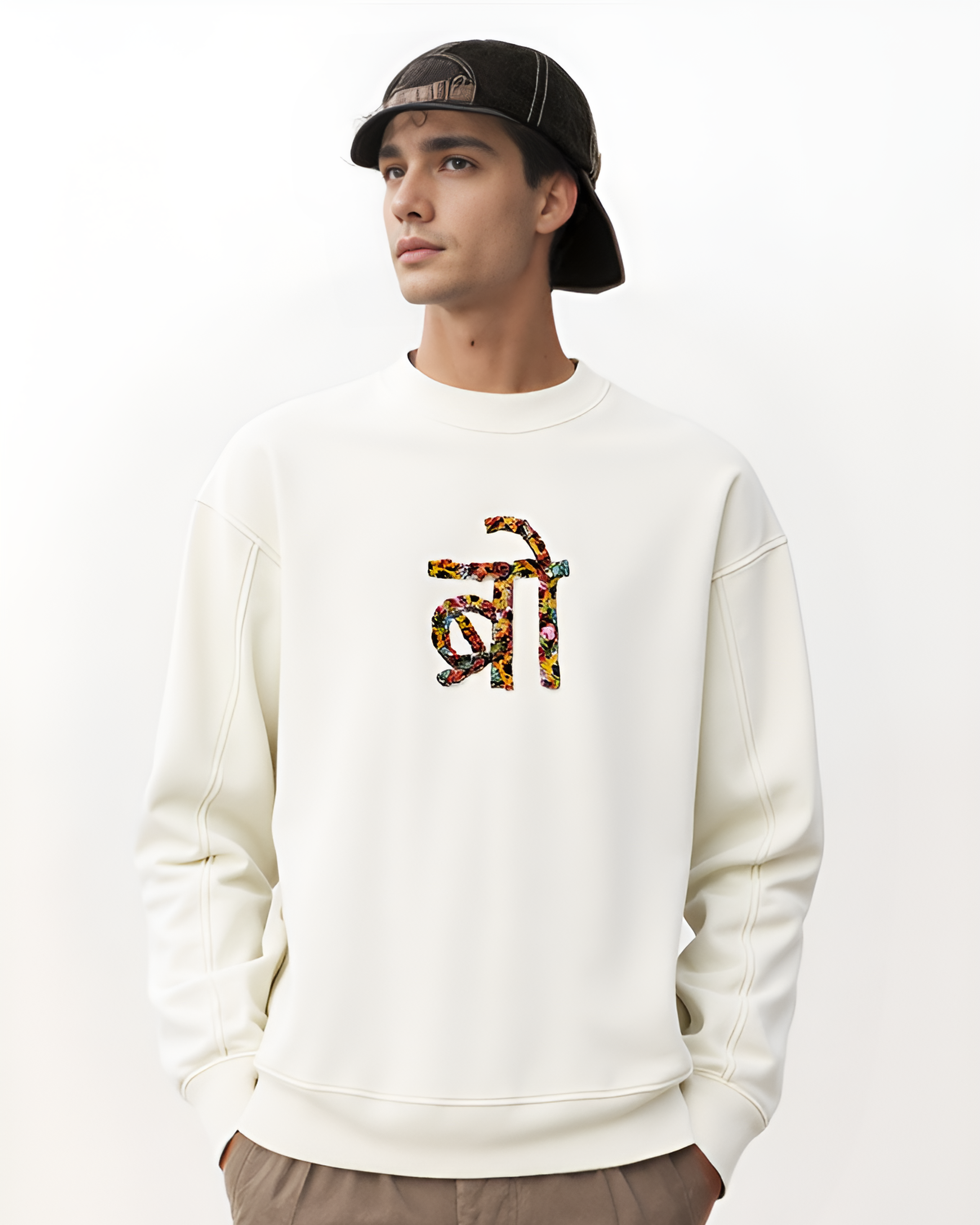 Side view of oversized sweatshirt featuring personalised name stitching, worn by model in an urban outdoor setting.