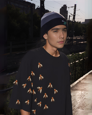 Unisex honey bee embroidered t-shirt worn by model in casual outdoor setting, symbolizing nature and handmade fashion.