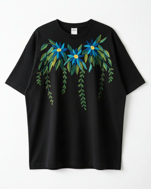 Black t-shirt with hand embroidered floral design on a white background