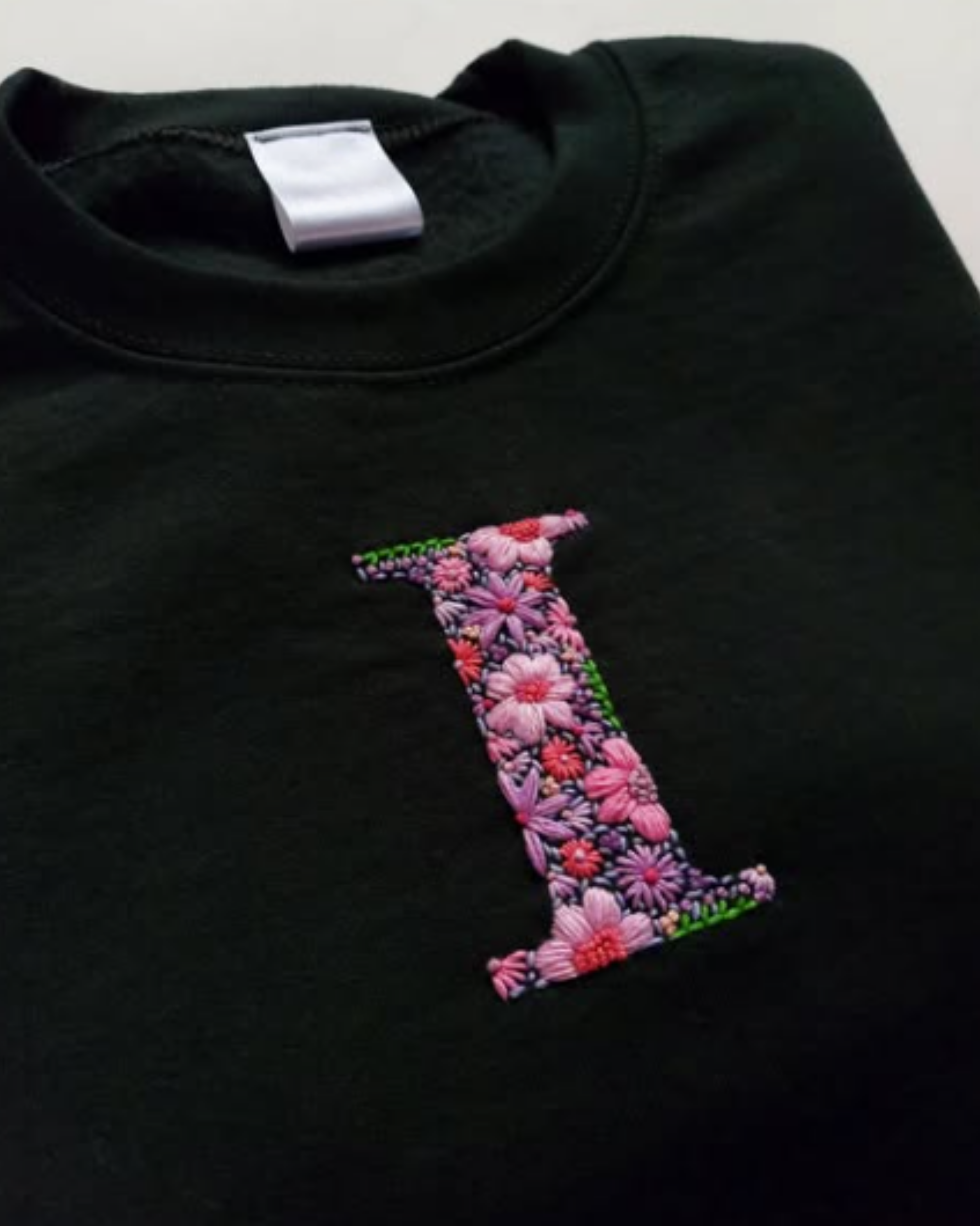 Flat lay of unisex custom name embroidery t-shirt made with 240 GSM cotton