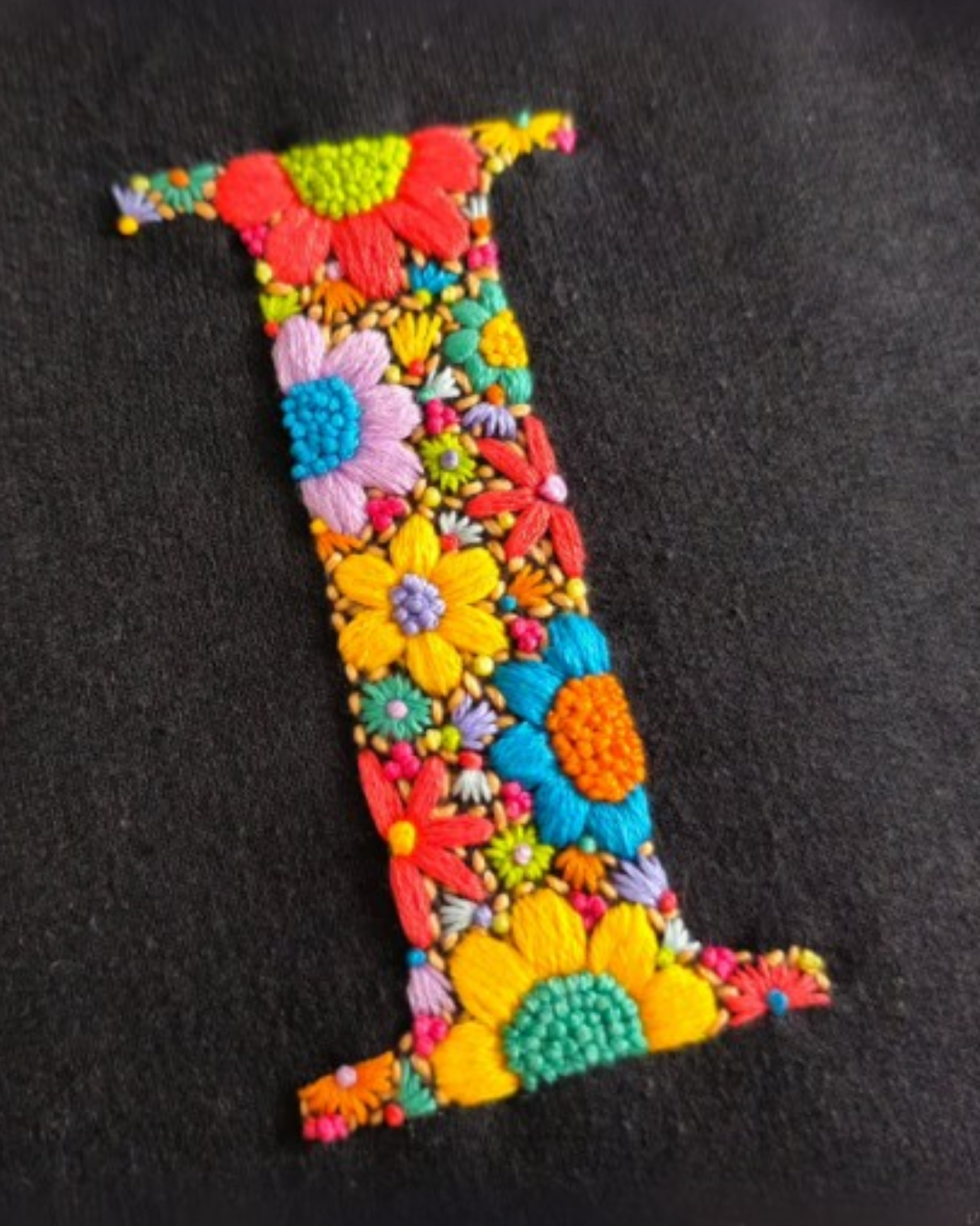 Premium cotton t-shirt with personalized embroidery displayed flat on surface