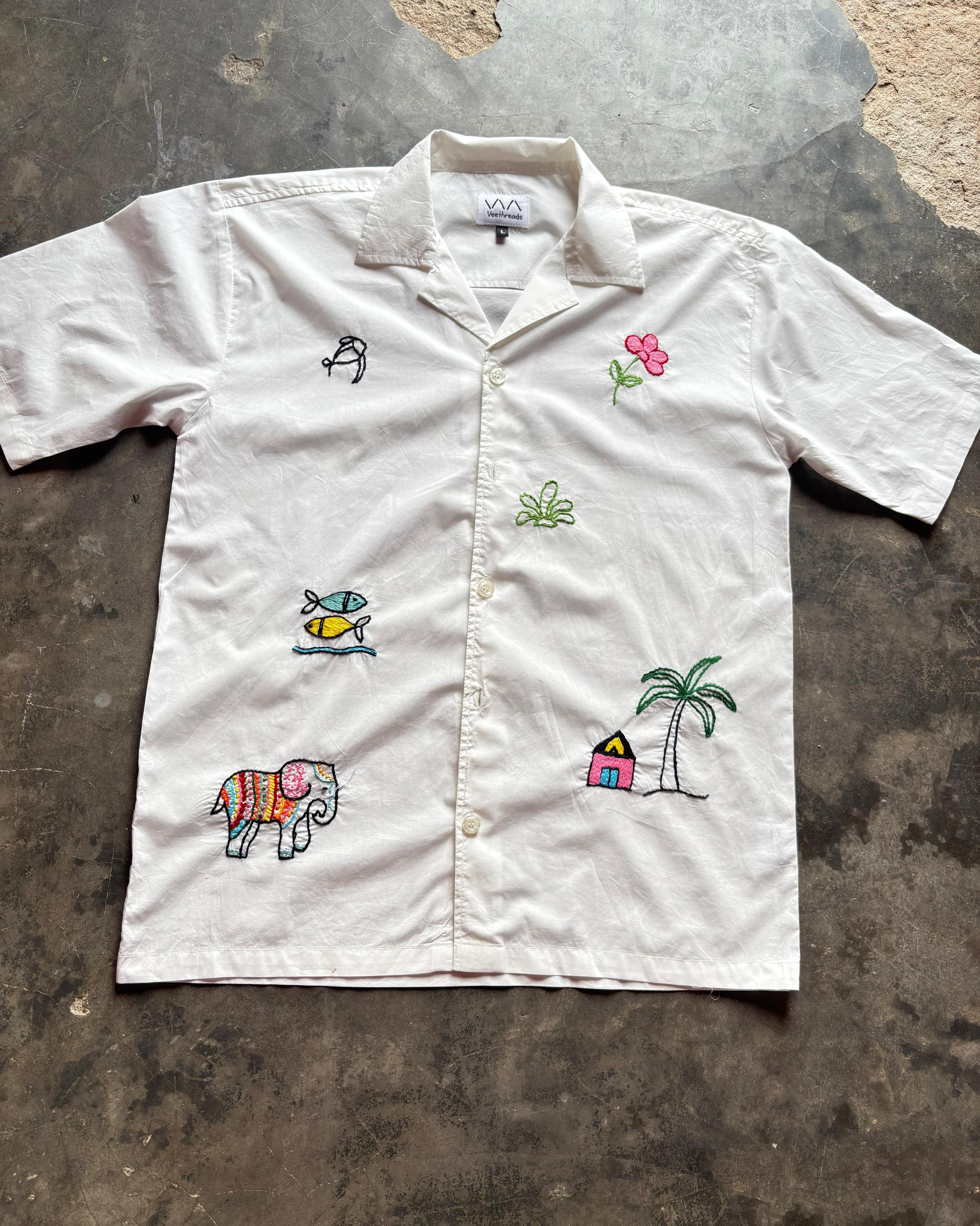 White shirt with colorful embroidery on a textured surface