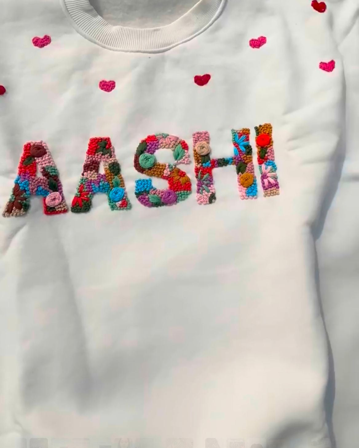 detailed shot of a custom name hand embroidered sweatshirt