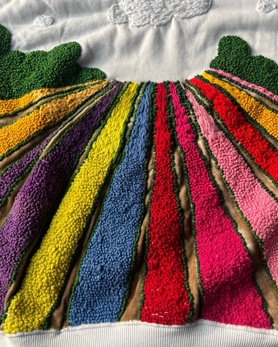 Colorful textured filed embroidered pattern on a white hoodies background