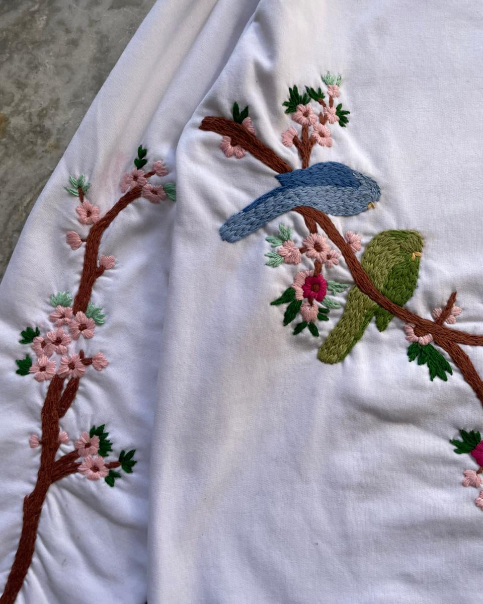 Embroidered Hoodie with birds and flowers on a white background
