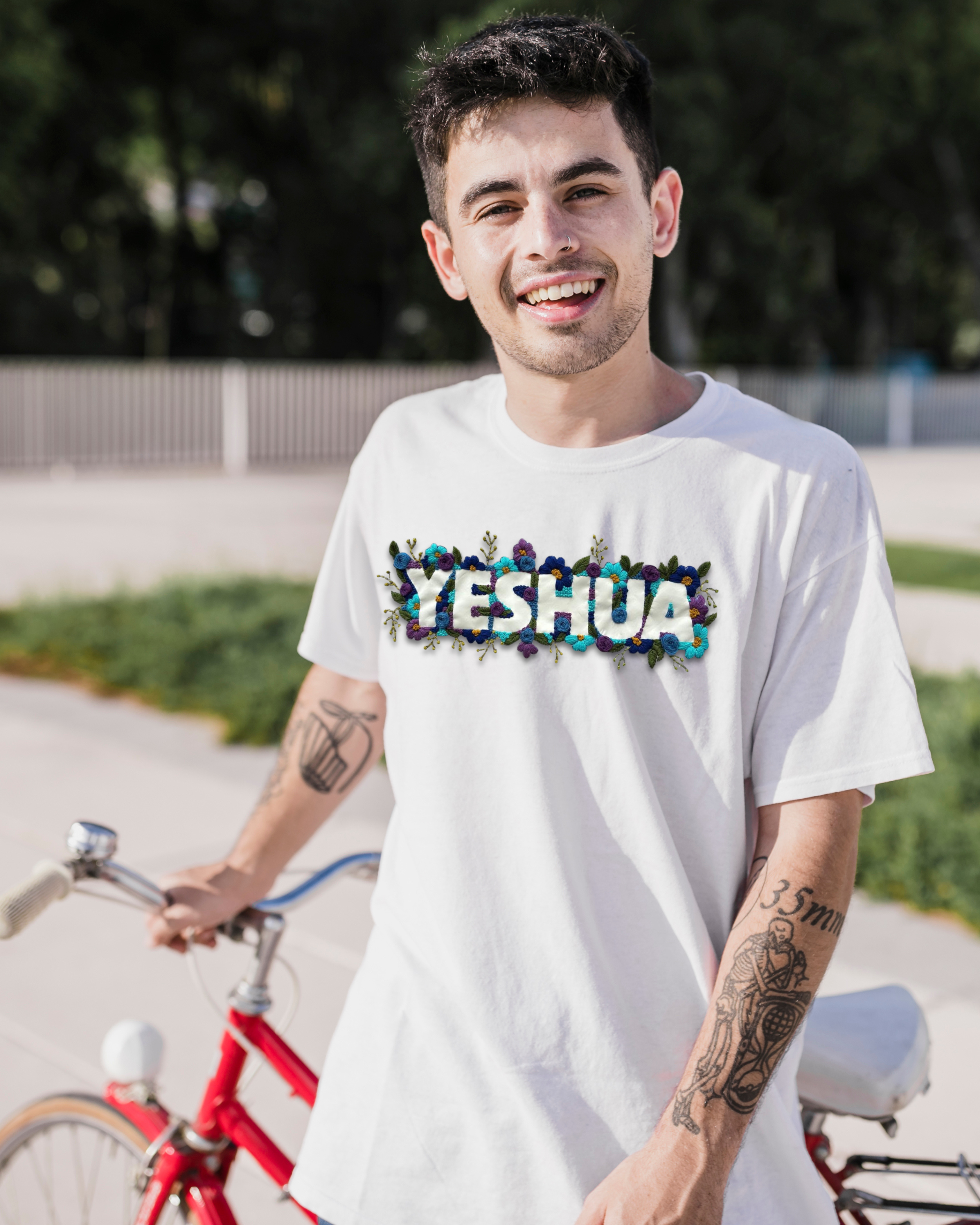 Model walking outdoors in a custom name embroidered tshirt, paired with oversized jeans and a tote bag.