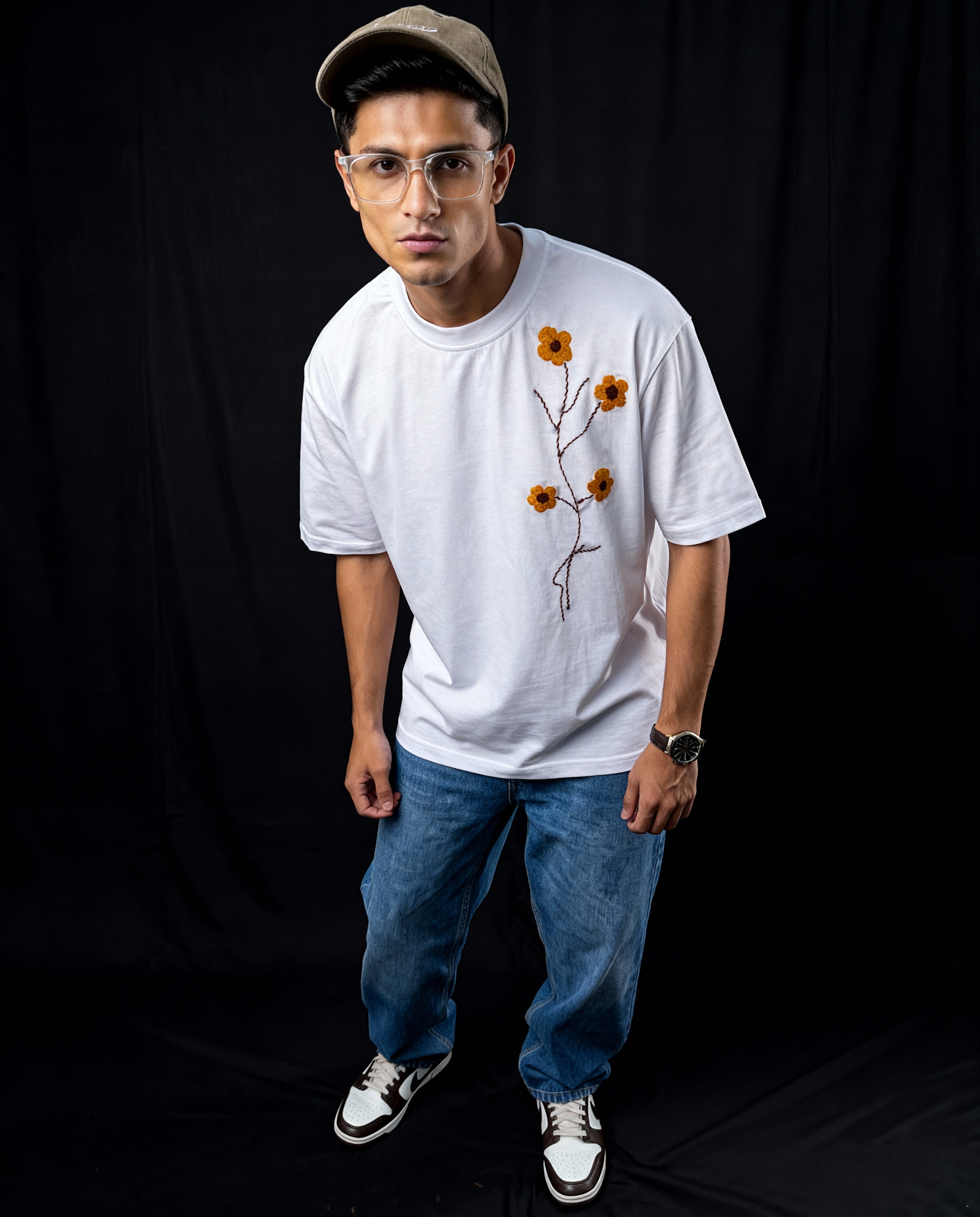 Hand embroidered floral cotton tshirt — model wearing white cotton tee with yellow floral hand-embroidered design, unisex fit