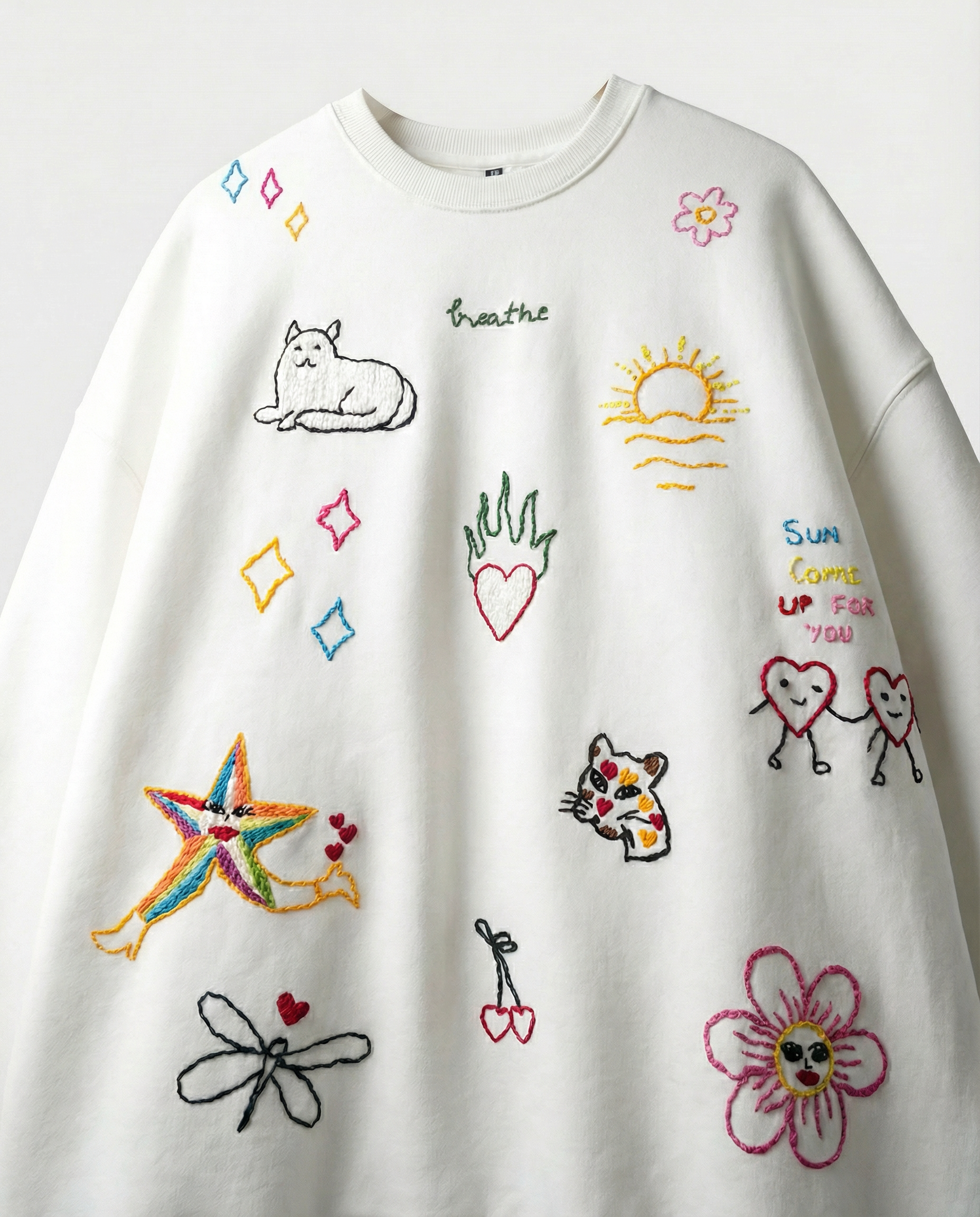 White shirt with colorful embroidered designs on a white background