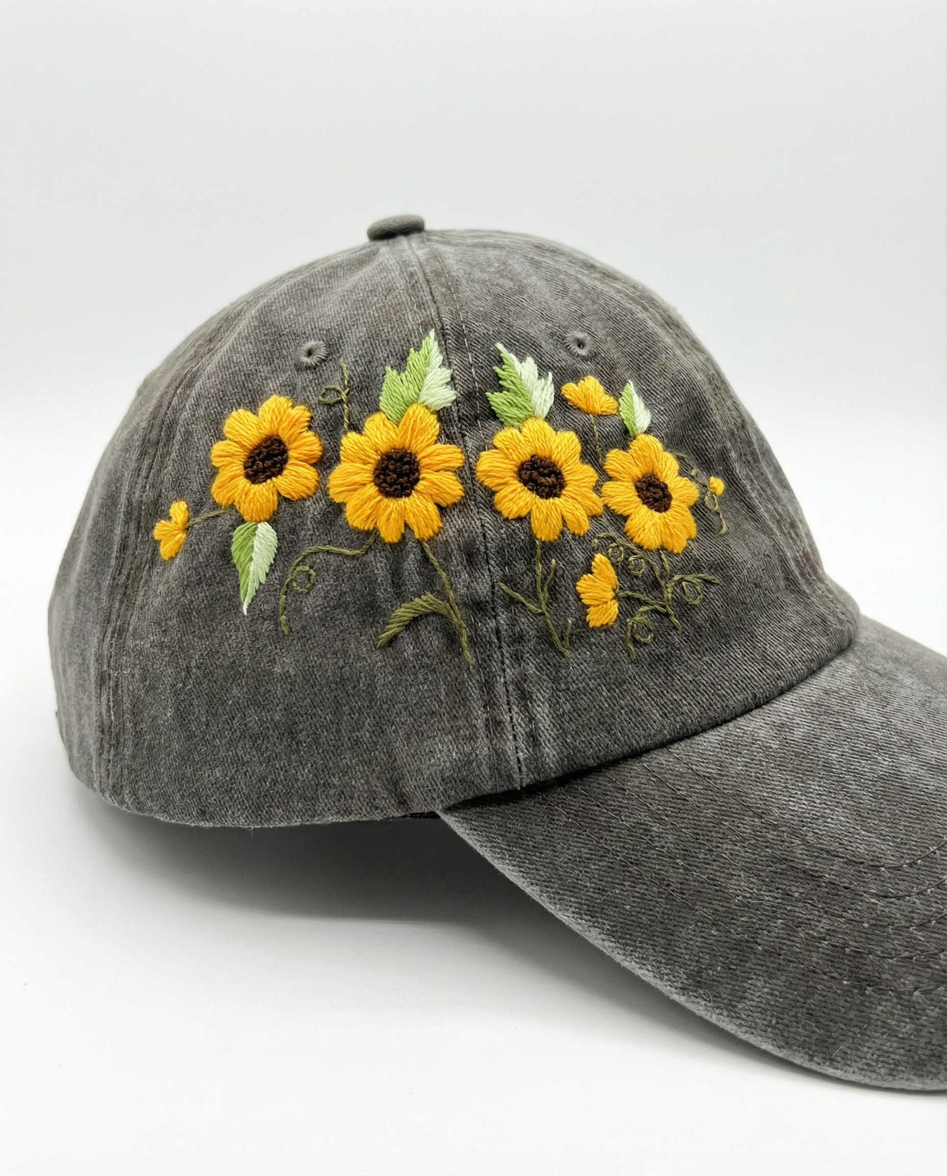 Gray cap with yellow floral embroidery on a white background