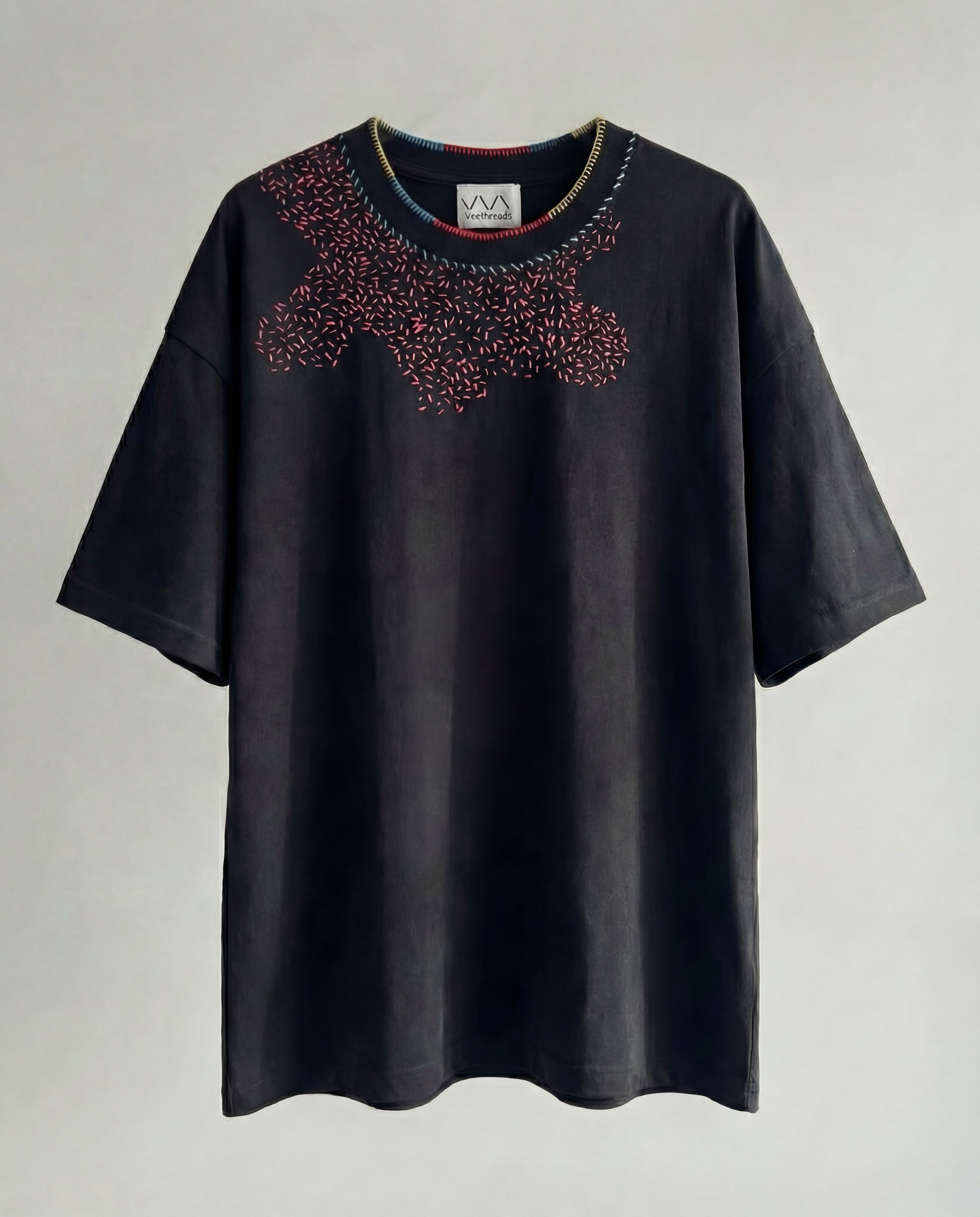 Black t-shirt with shashiko embroidery on a light gray background