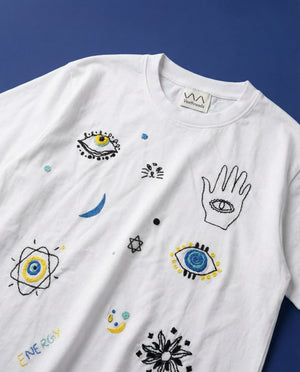 Cosmic energy hand embroidered tee — white cotton tee with hand-embroidered cosmic doodle designs in colourful thread on blue background