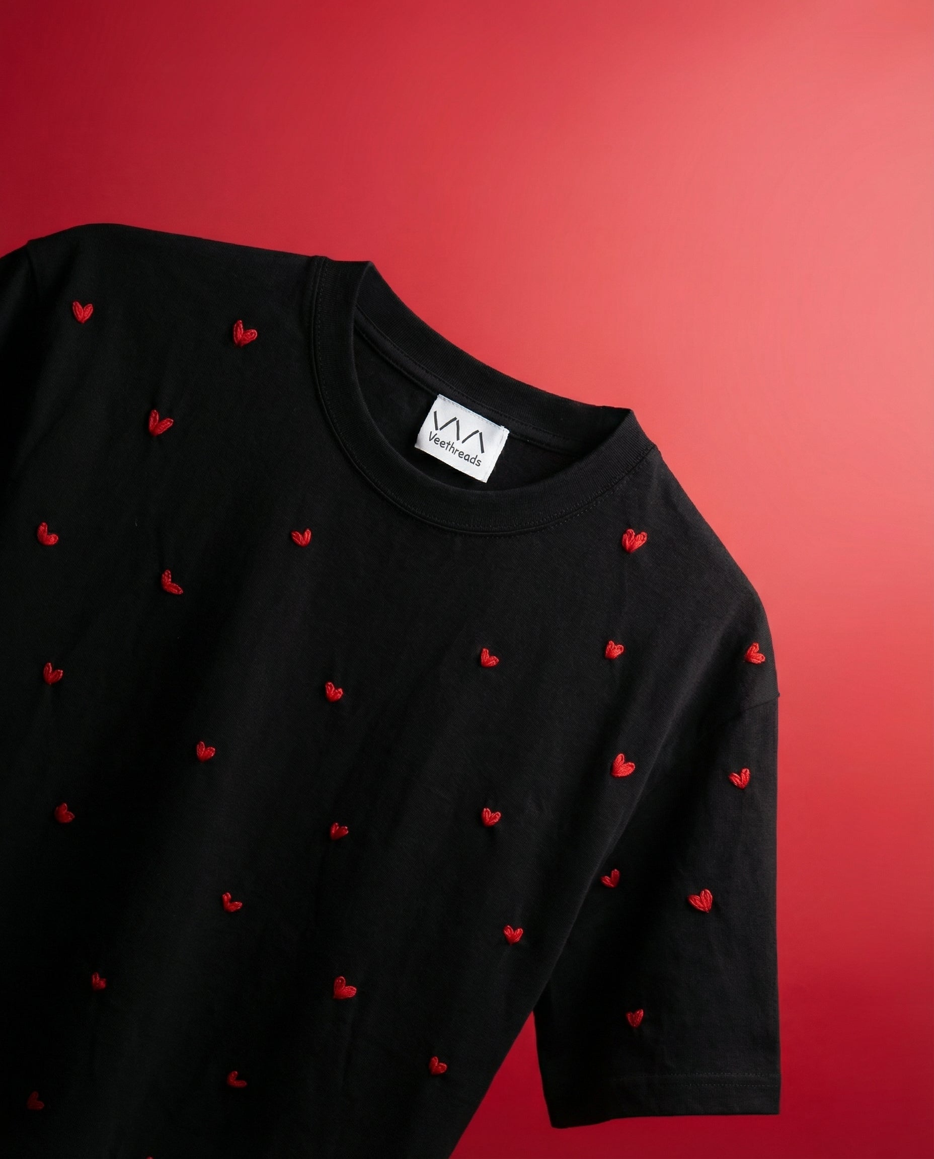 flatlay of red heart shirt on a red background
