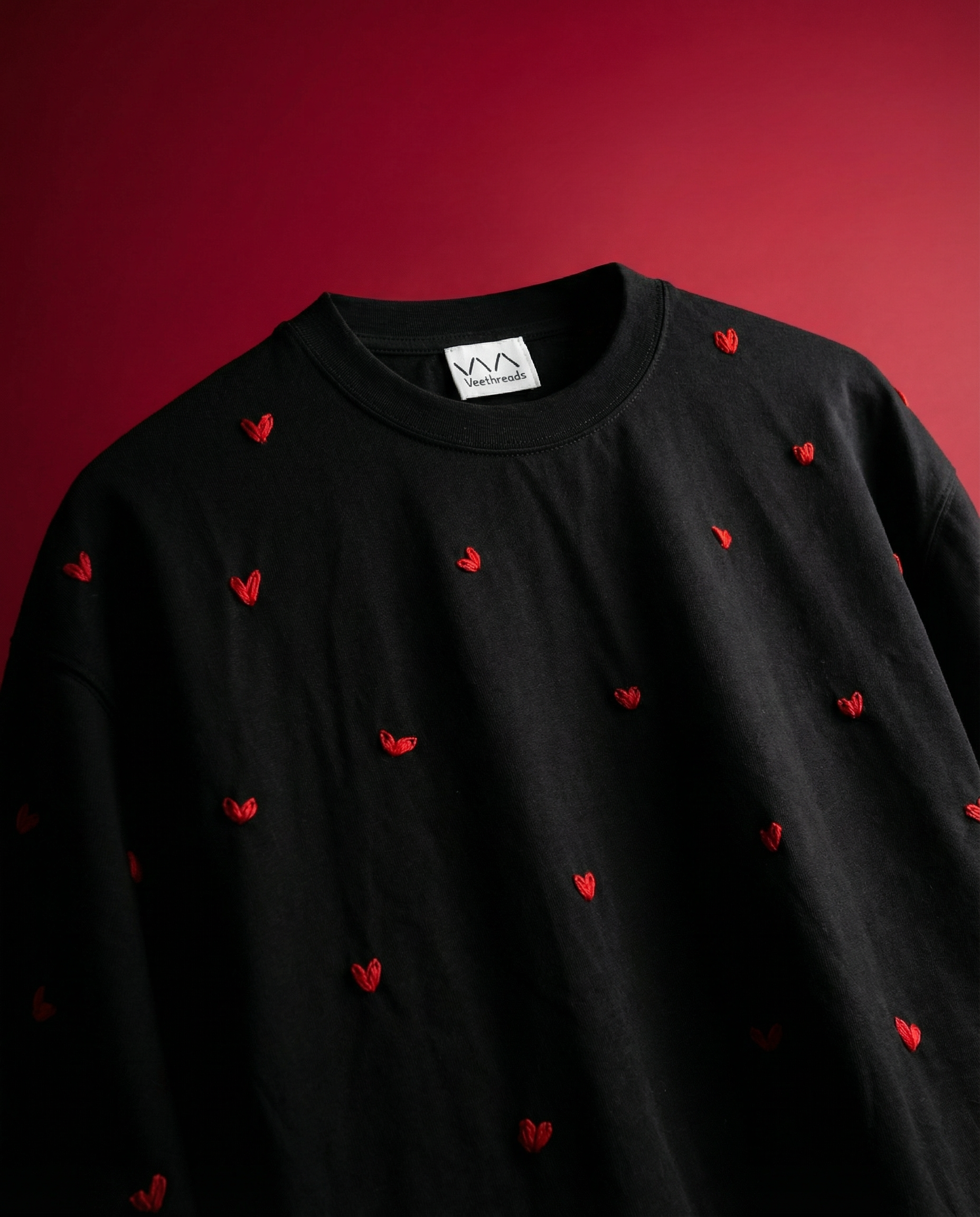 white shirt with red heart embroidered on a red background