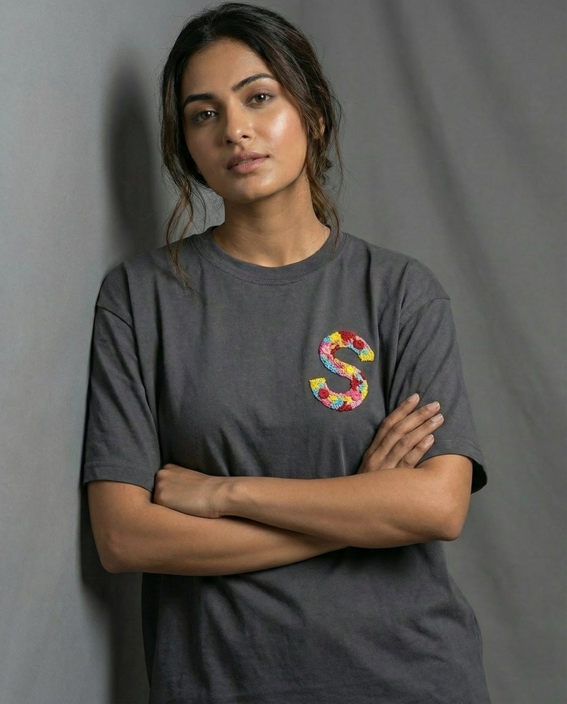 Personalised initials hand-stitched on a cotton oversized tee — choose your letters, embroidered by women artisans at Vee Threads.