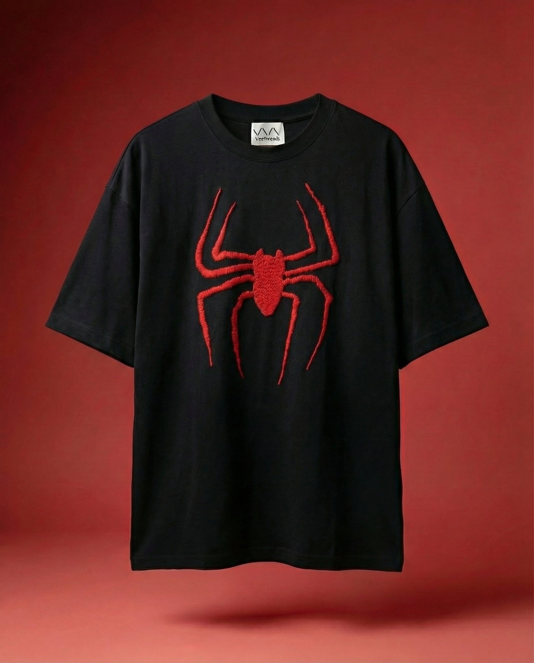 Black t-shirt with a red spider graphic on a red background