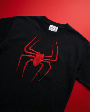 Black t-shirt with a red spiderman design on a red background