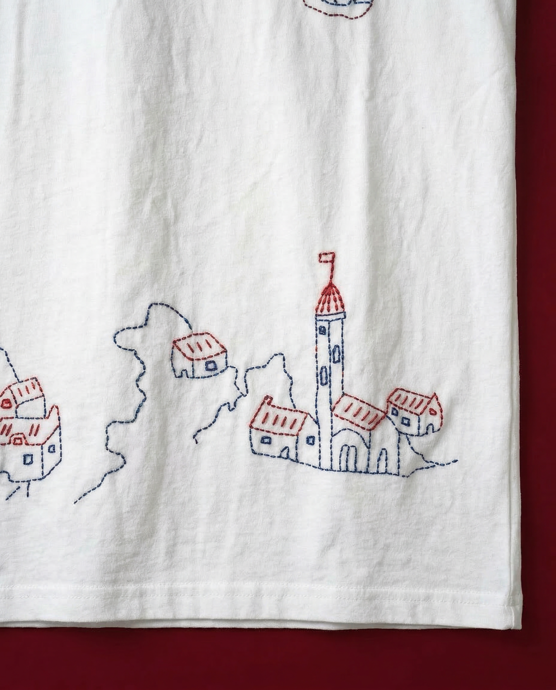 close up hand embroidery stitches on white cotton t shirt village design