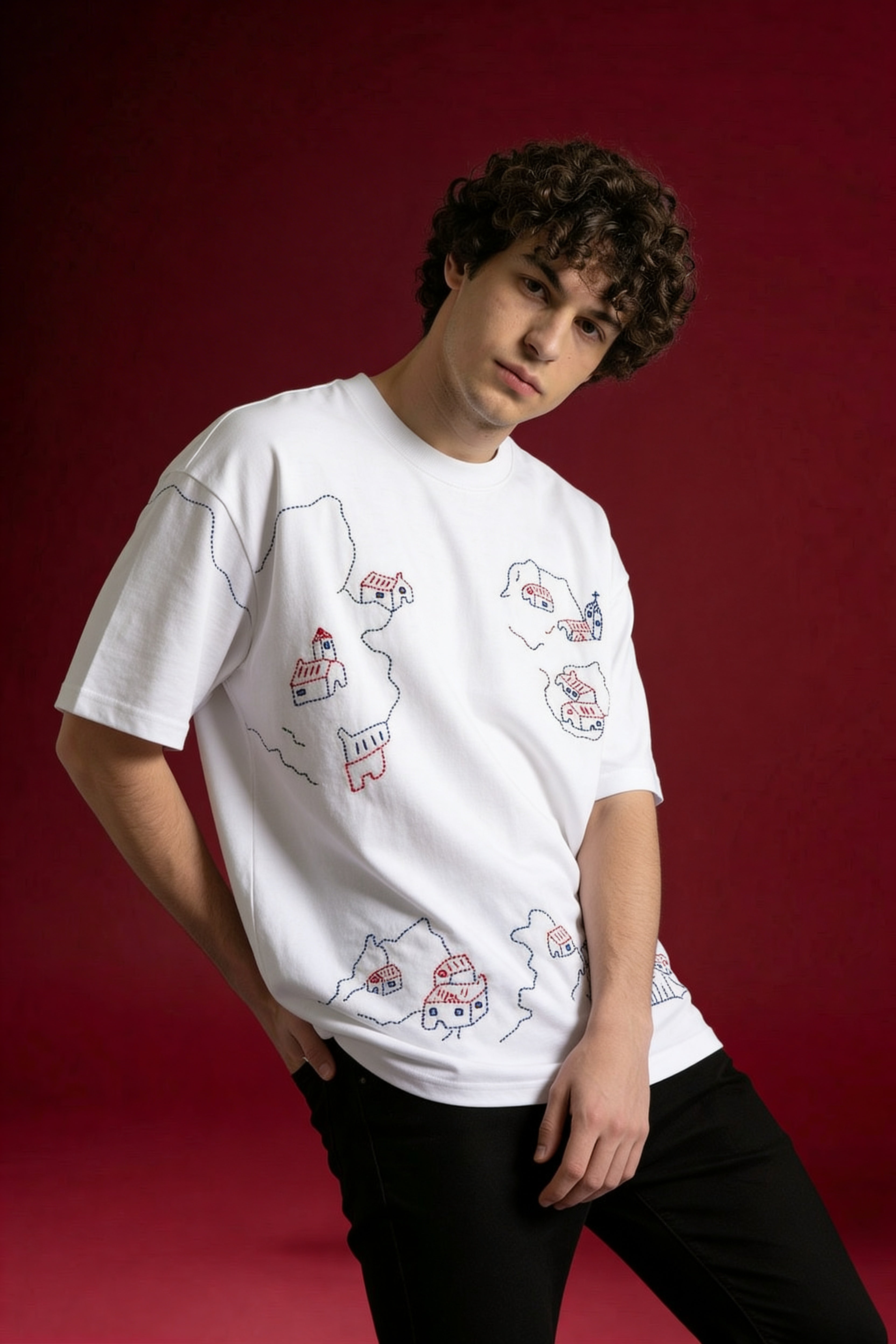 model wearing white hand embroidered village t shirt oversized cotton shirt