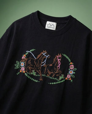 Wild prairie horse embroidered sweatshirt — black sweatshirt with hand-embroidered prancing horses and floral wreath on green background