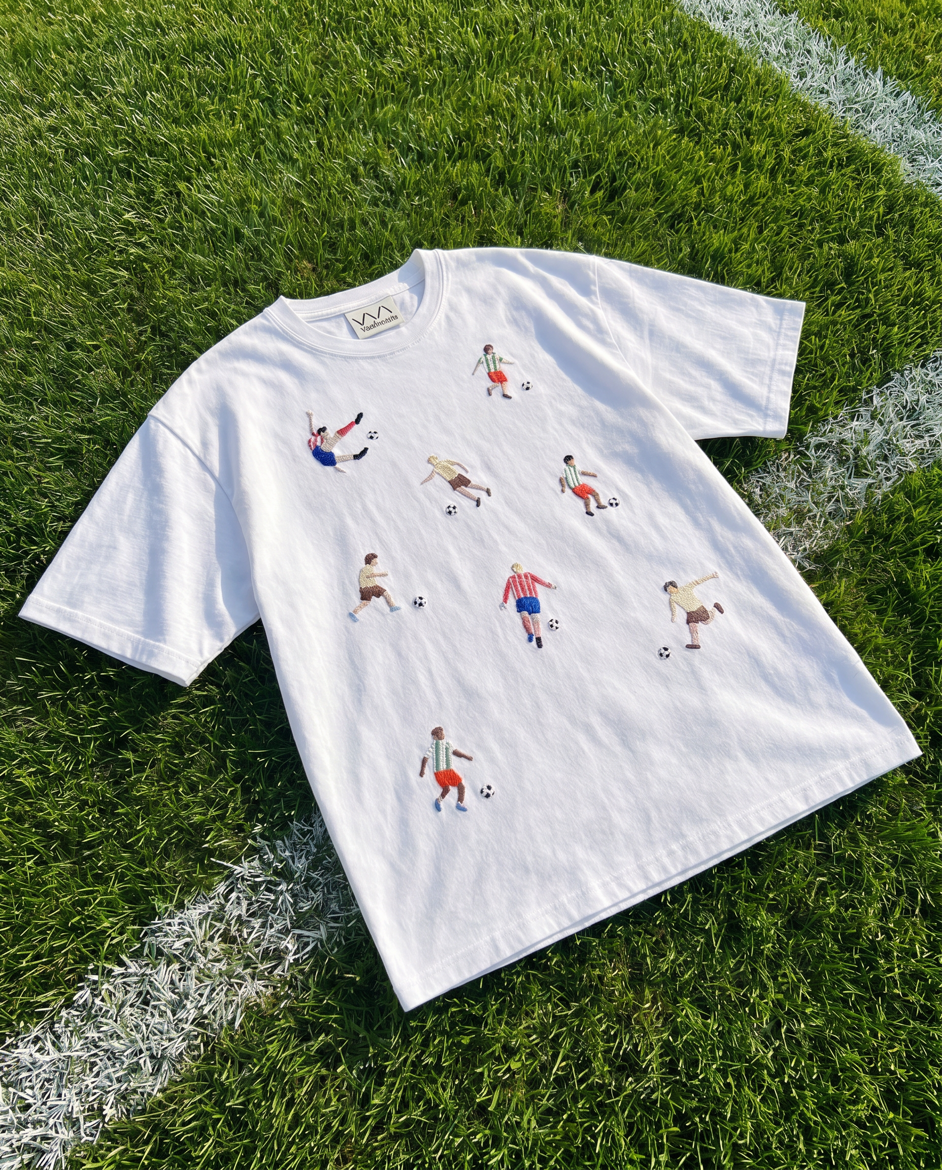 Hand-embroidered footballers and soccer balls on a white cotton tee, by Vee Threads