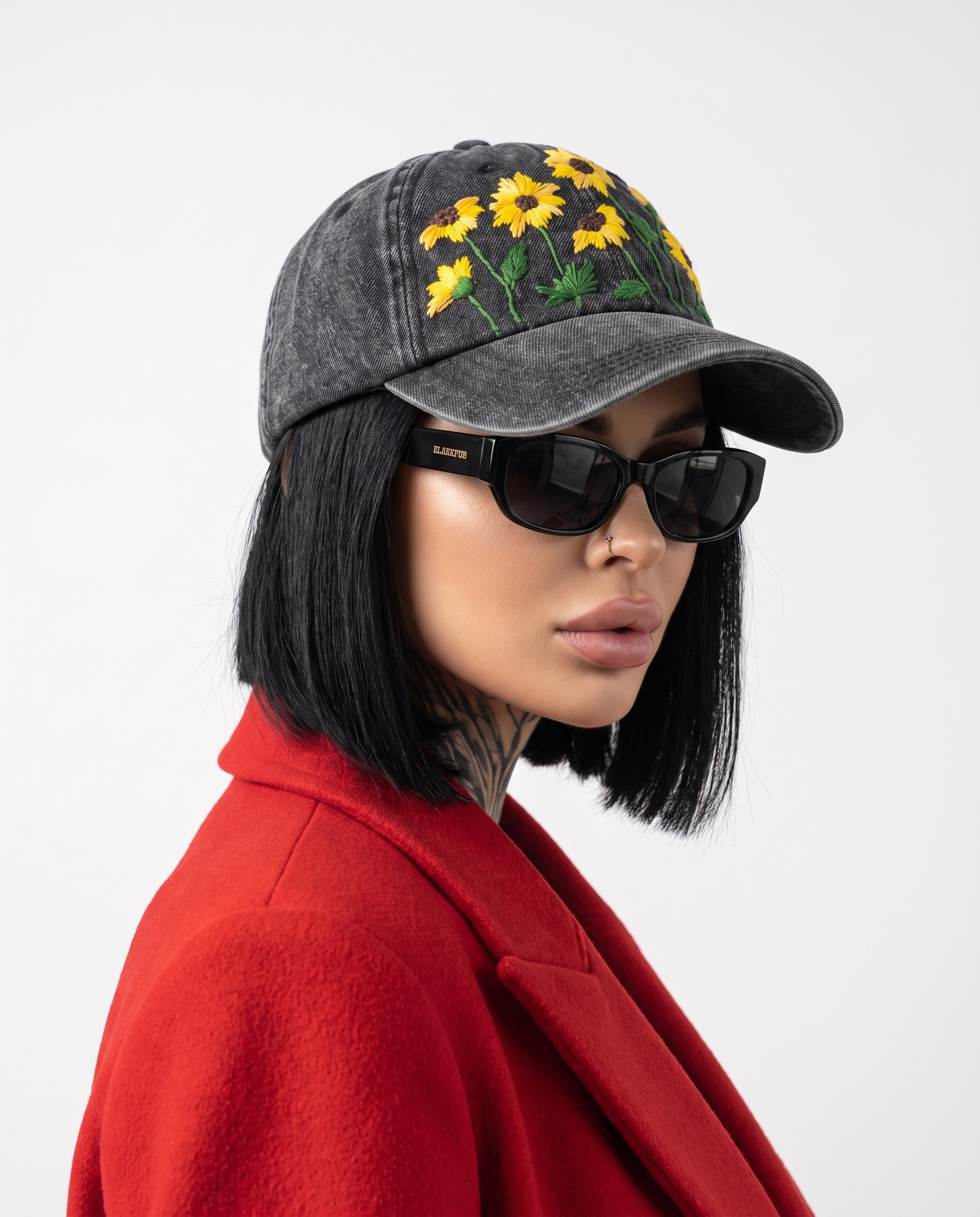 Model wearing Vee Threads sunflower field hand-embroidered denim cap (unisex), front view with yellow blooms