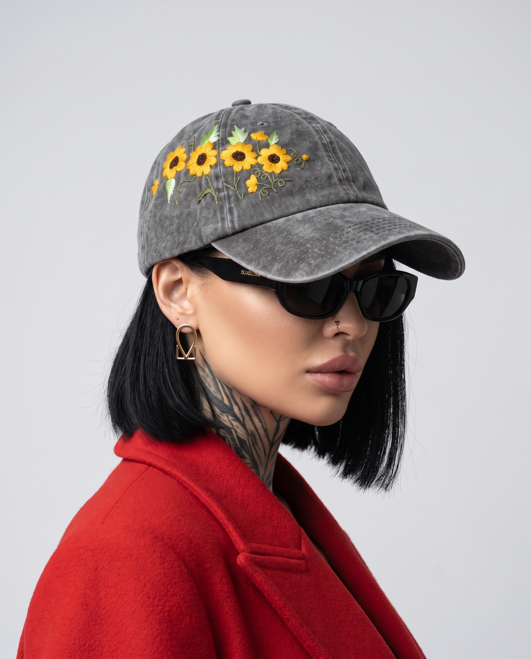 Model wearing Vee Threads sunflower hand-embroidered baseball cap, front view with yellow bloom