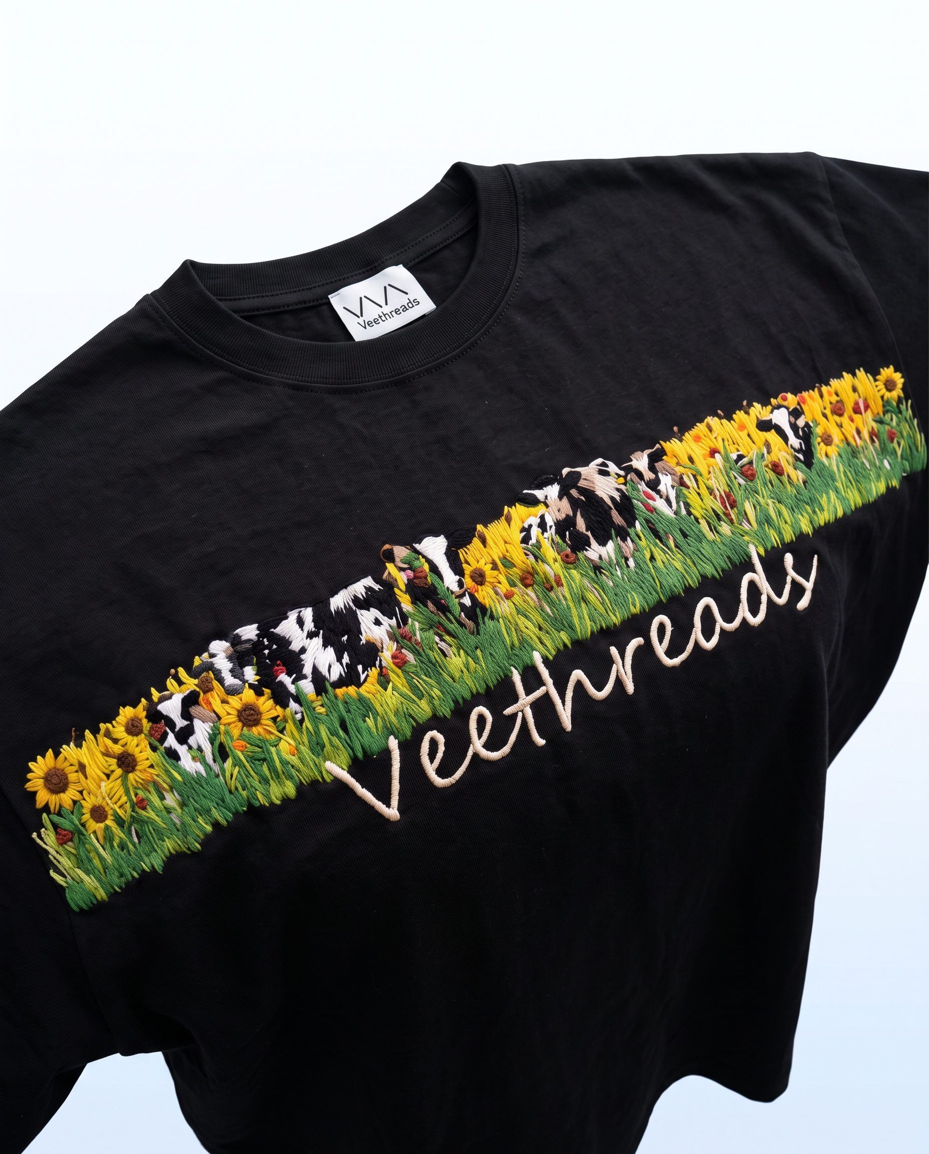 Vee Threads woven label and hand embroidered sunflower meadow band on black oversized cotton t-shirt