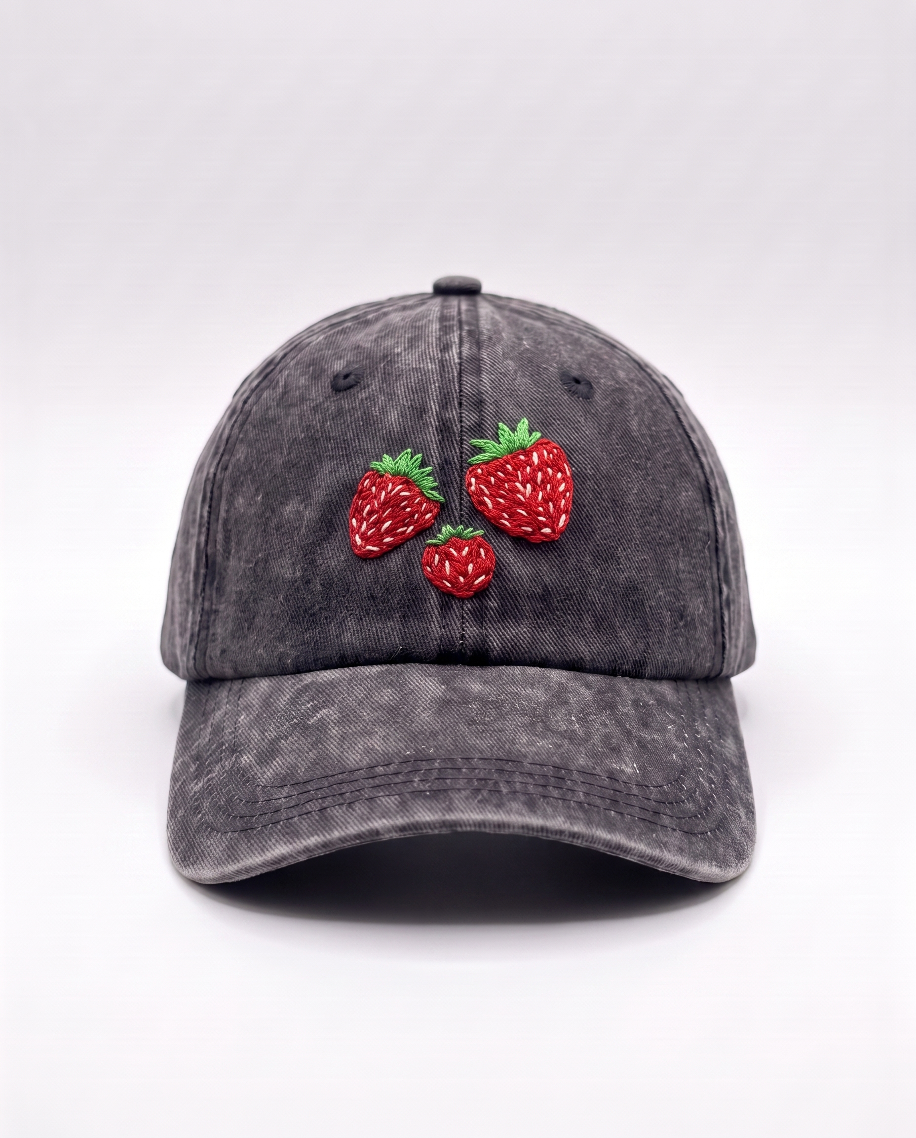 Washed black cotton baseball cap with three hand-embroidered strawberries on the front panel