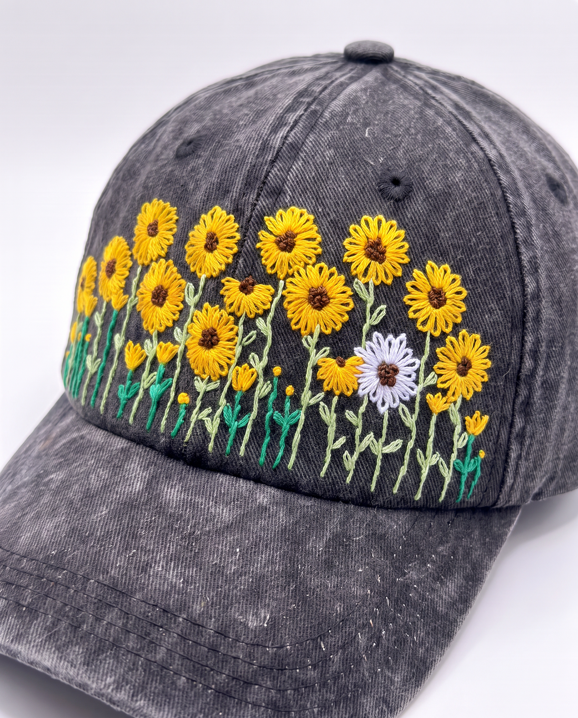 Angled view of the sunflower meadow cap showing the white daisy and the raised petal stitching up close