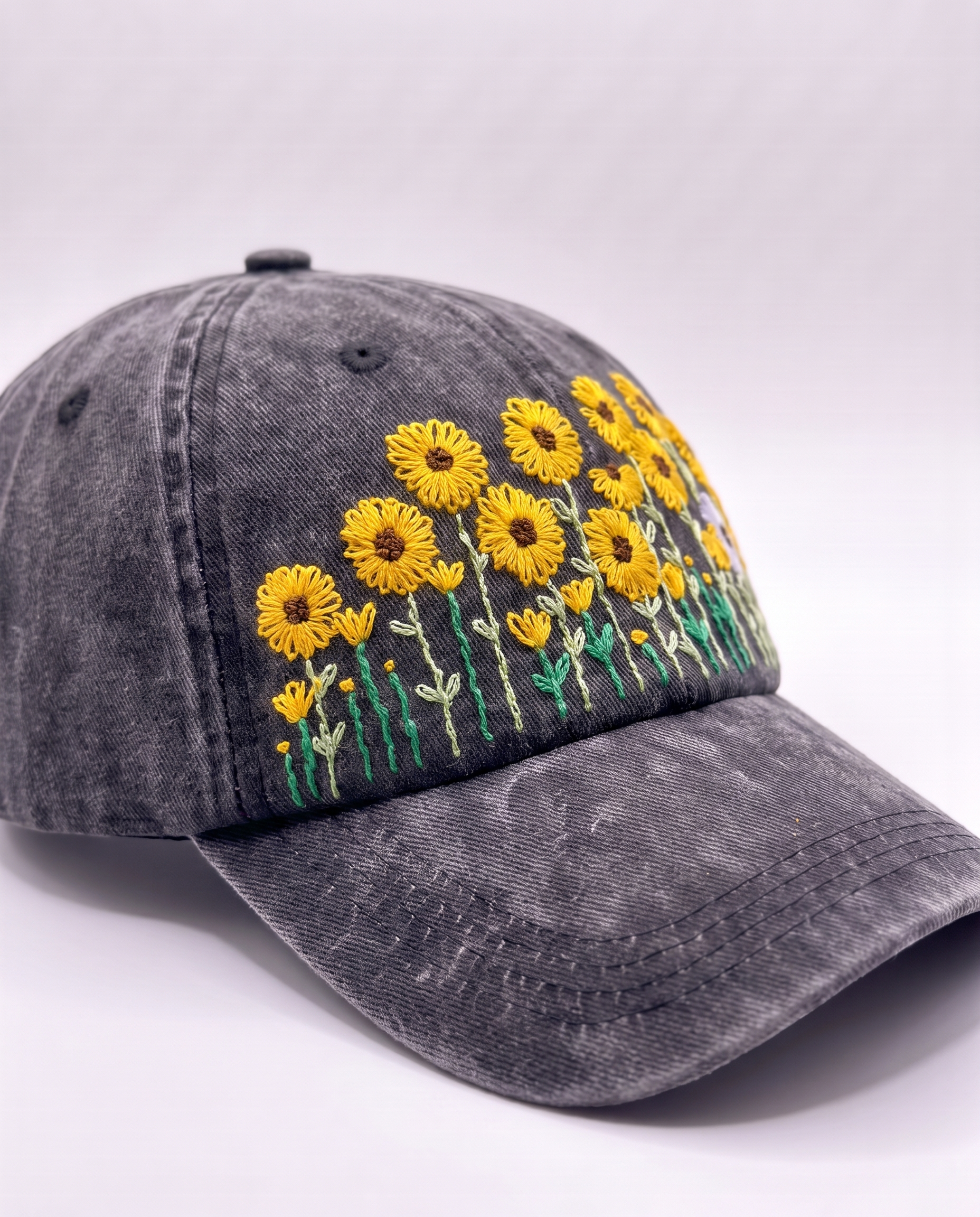 Sunflower embroidered cap at an angle, stitched stems running from the brim past the front seam onto the side panel