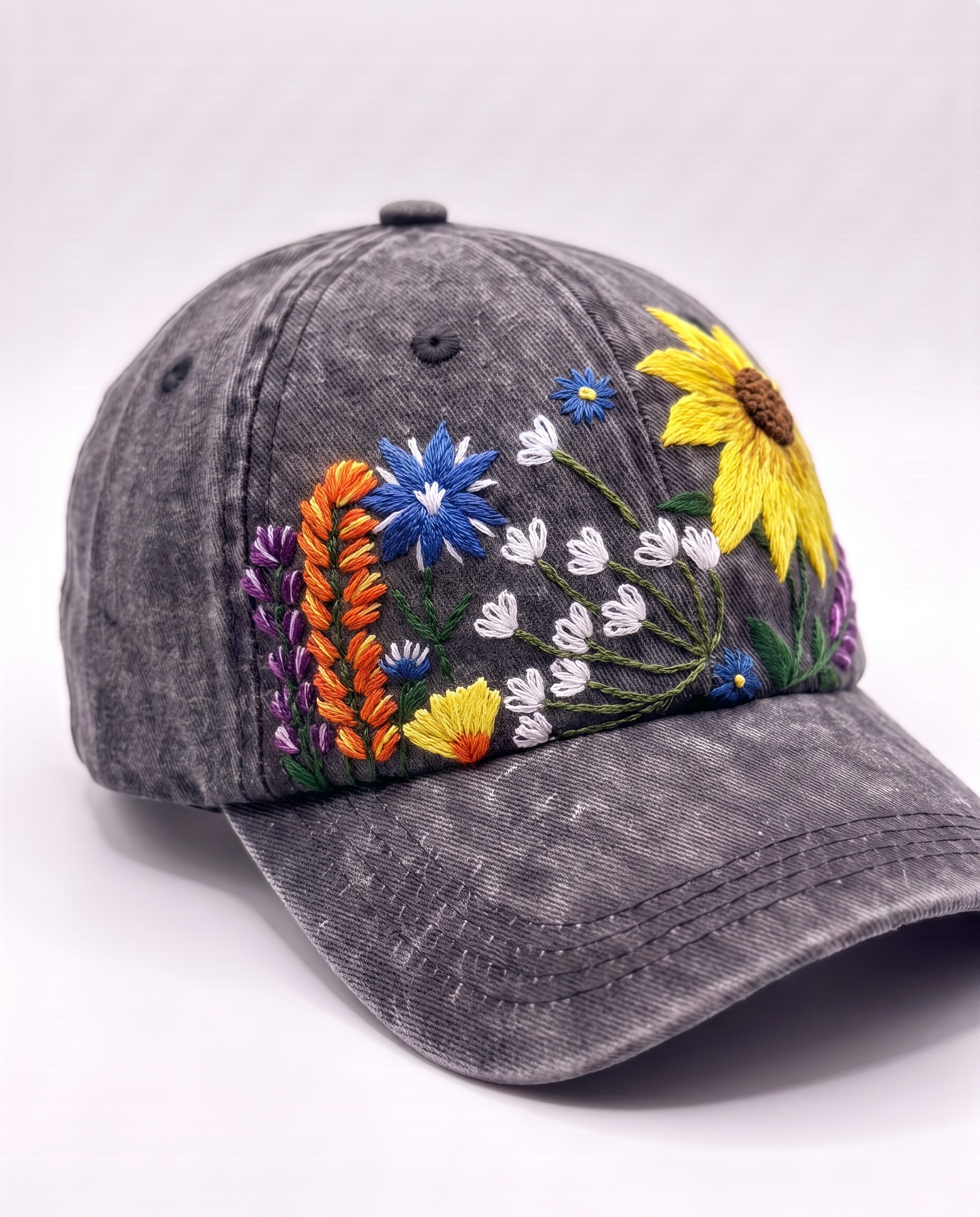 Angled view of the wildflower garden cap, embroidery running from the front panel onto the side