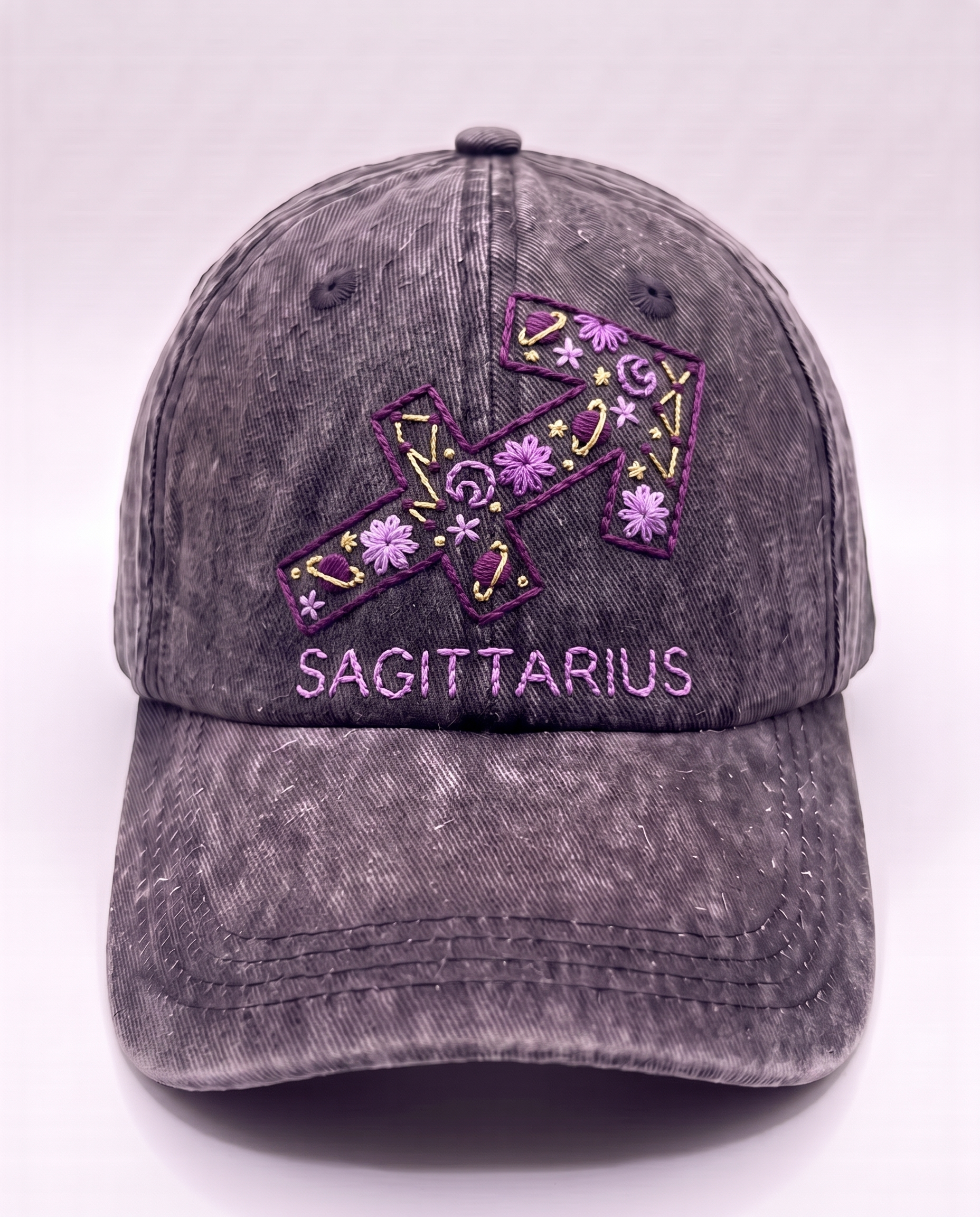 Sagittarius zodiac cap, purple arrow glyph hand-embroidered on charcoal acid-wash denim