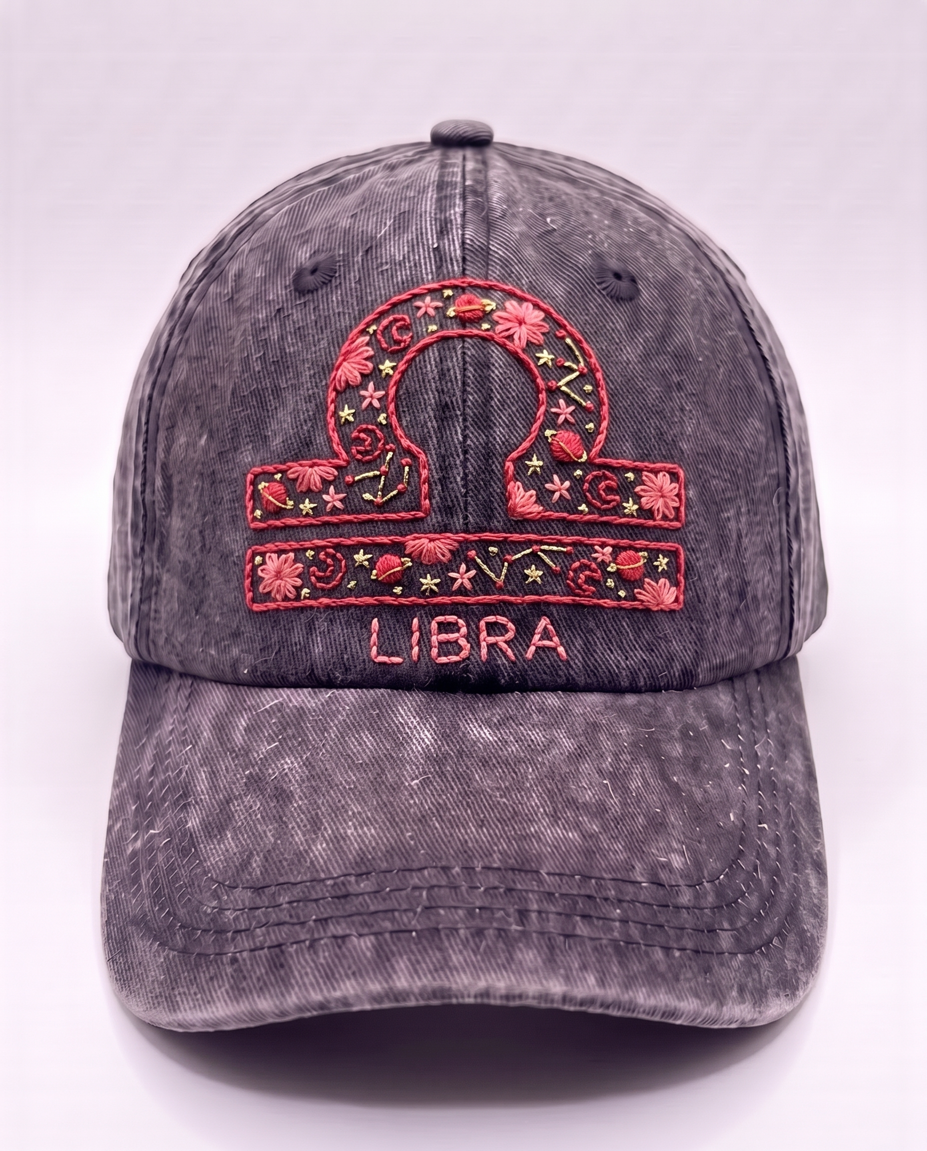 Hand-embroidered Libra star sign cap in coral and pink thread on washed denim