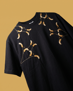 Kanak hand-embroidered oversized t-shirt in white with golden wheat embroidery across the neckline, shoulders and chest