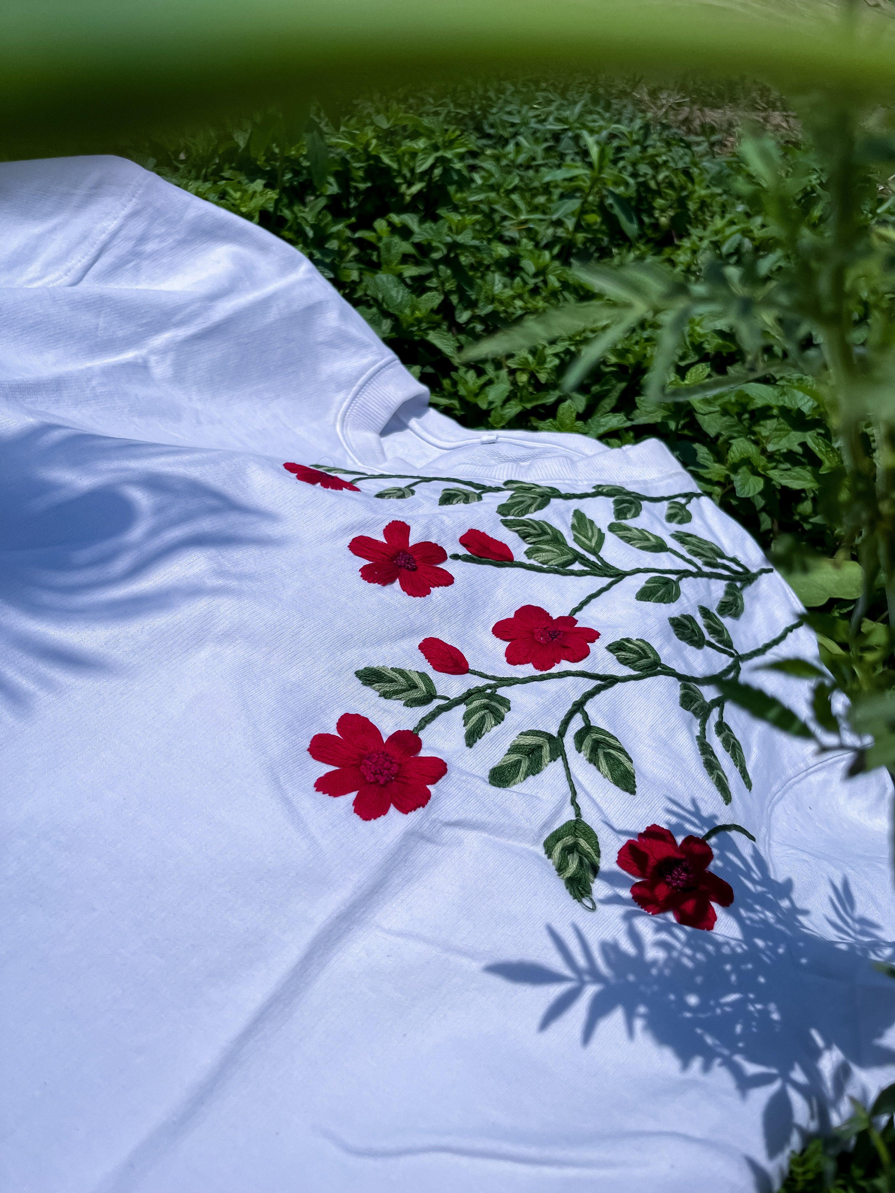 Black oversized cotton tee with scarlet petals and green leaves hand-embroidered on the chest