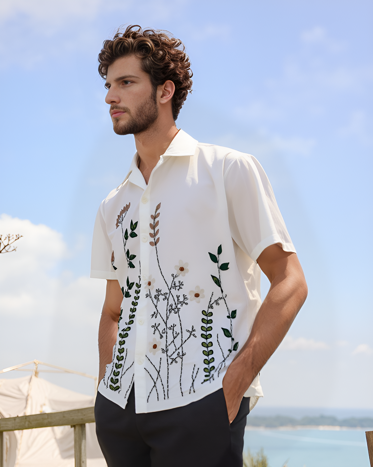 Floral motif hand embroidered in deep coloured thread on white cotton