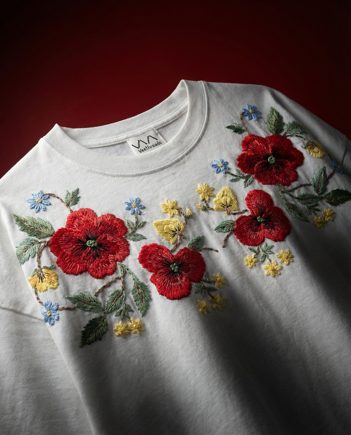 Floral hand-embroidered t-shirt - red flowers and green vines stitched in real thread on cotton